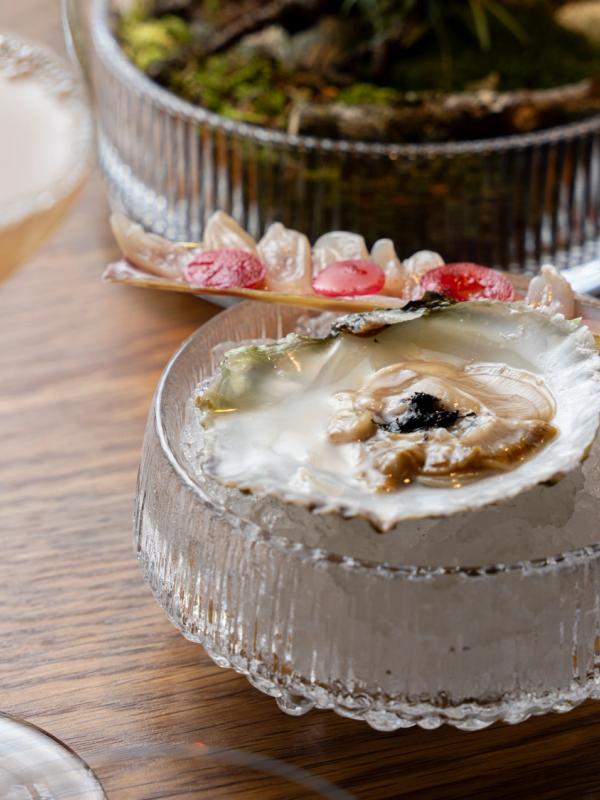 Apple juice, oyster and razor shell served at the Credo restaurant at The National Library in Oslo