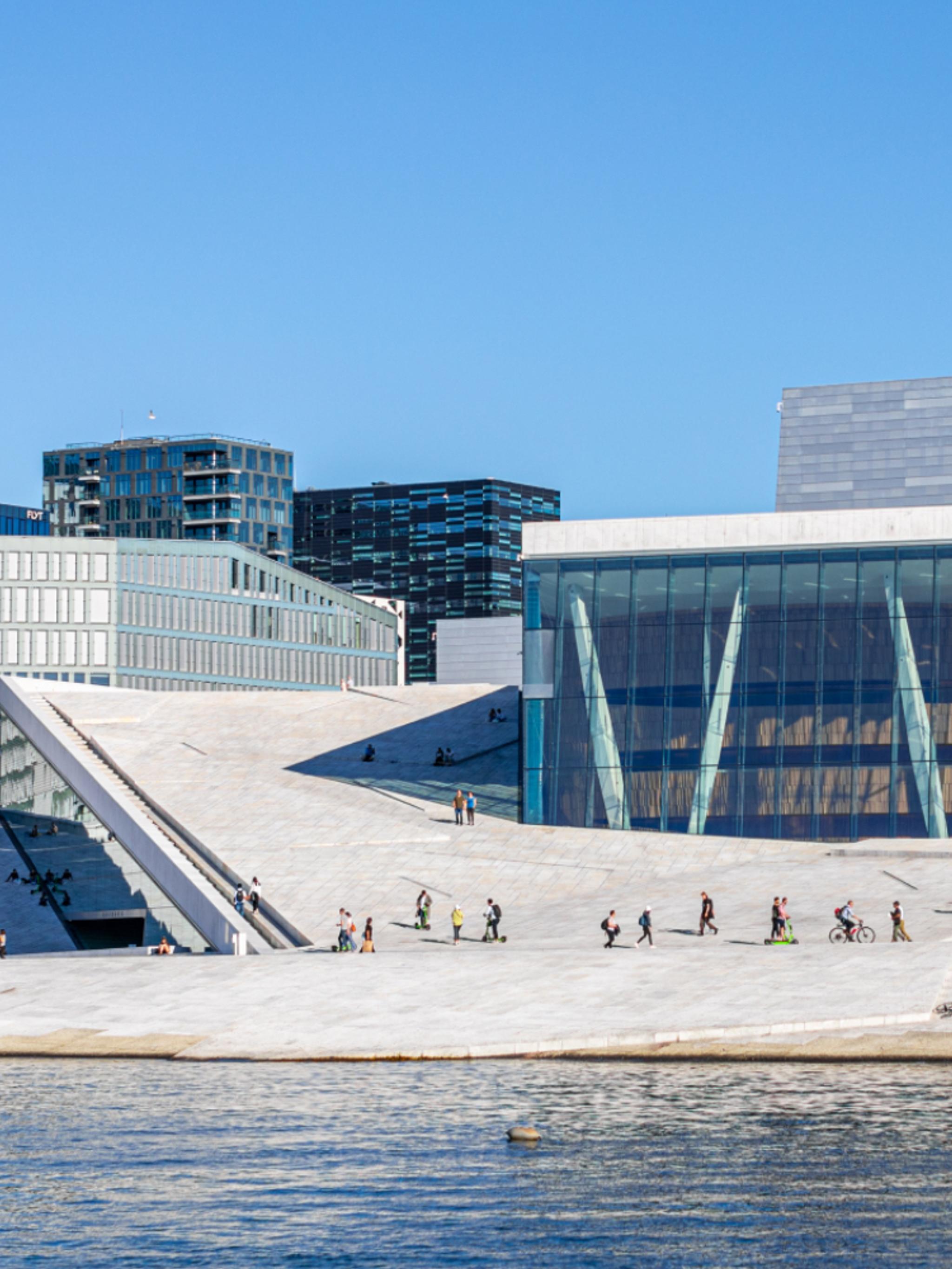 People walking across the roof of The Oslo Opera House