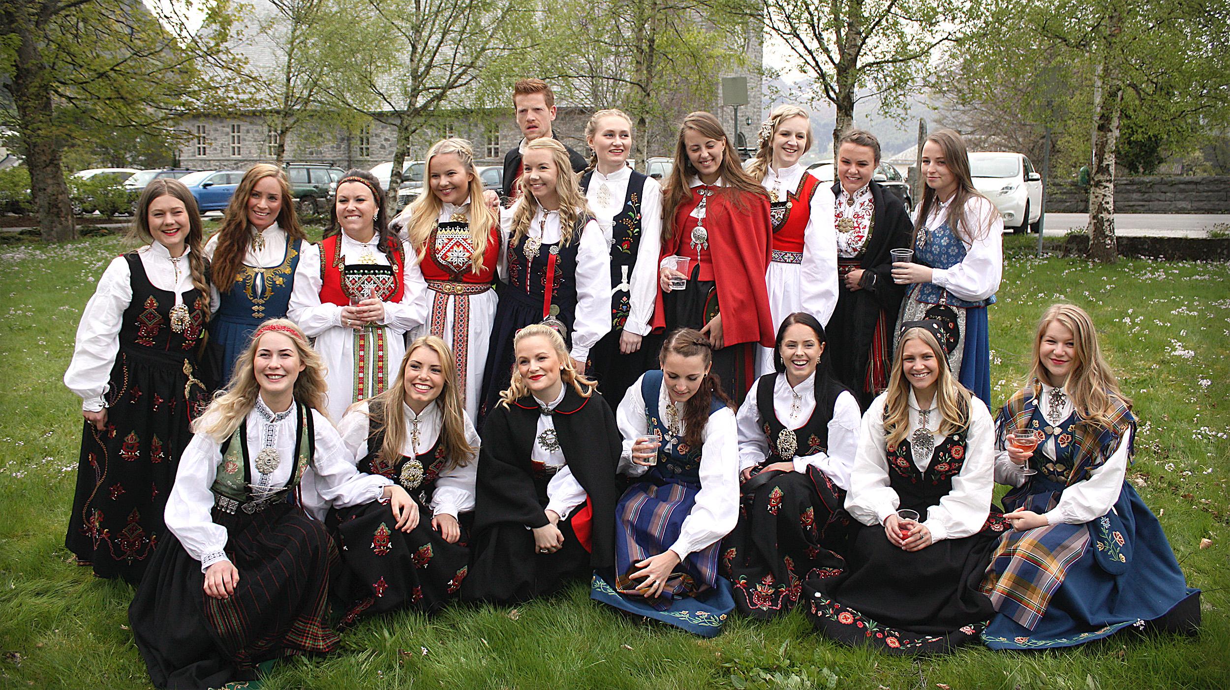Many women and a man in different bunads, traditional costumes on graduation in Volda in Fjord Norway