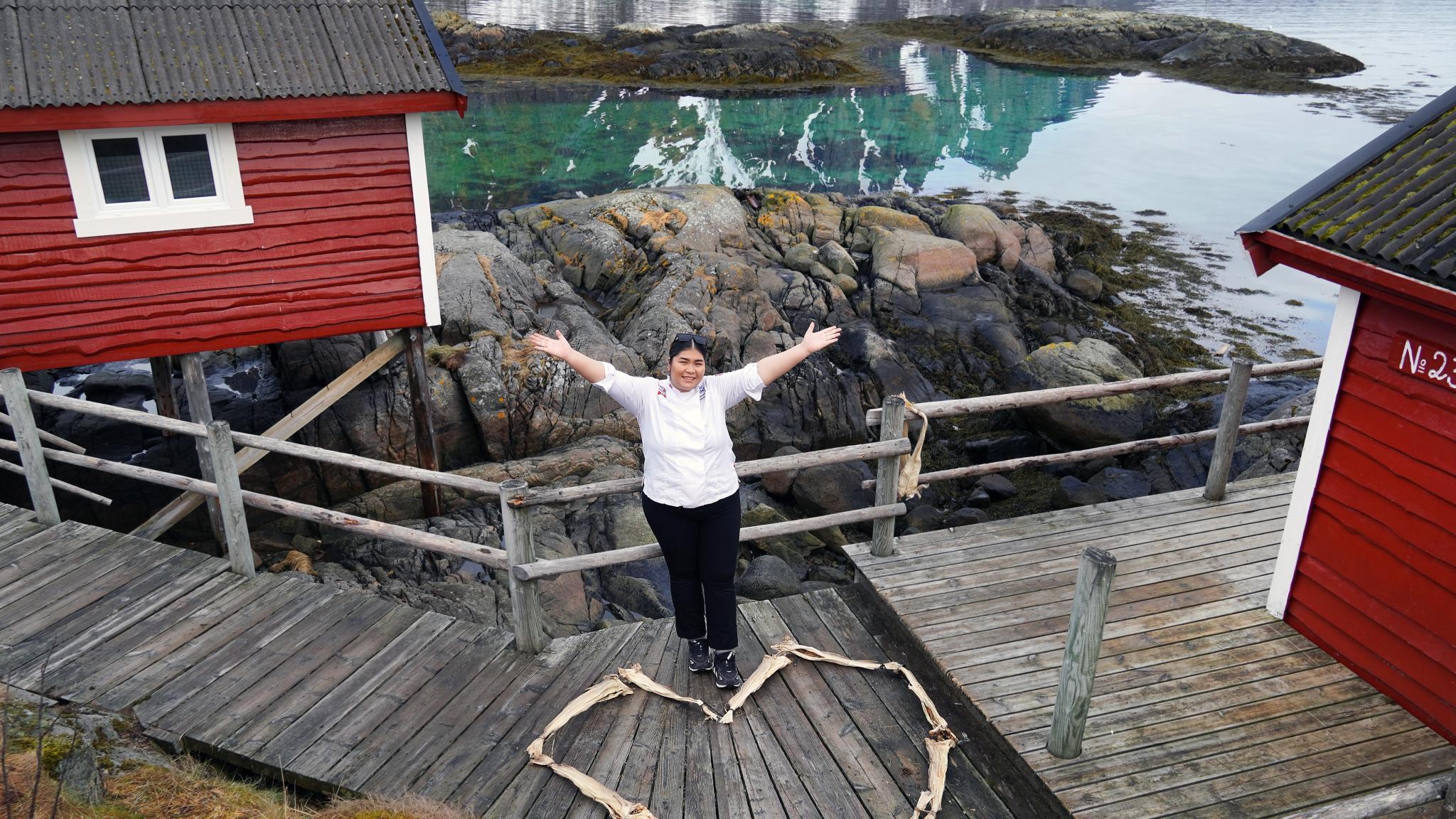 Stockfish heart and woman chef in front of a red cabin