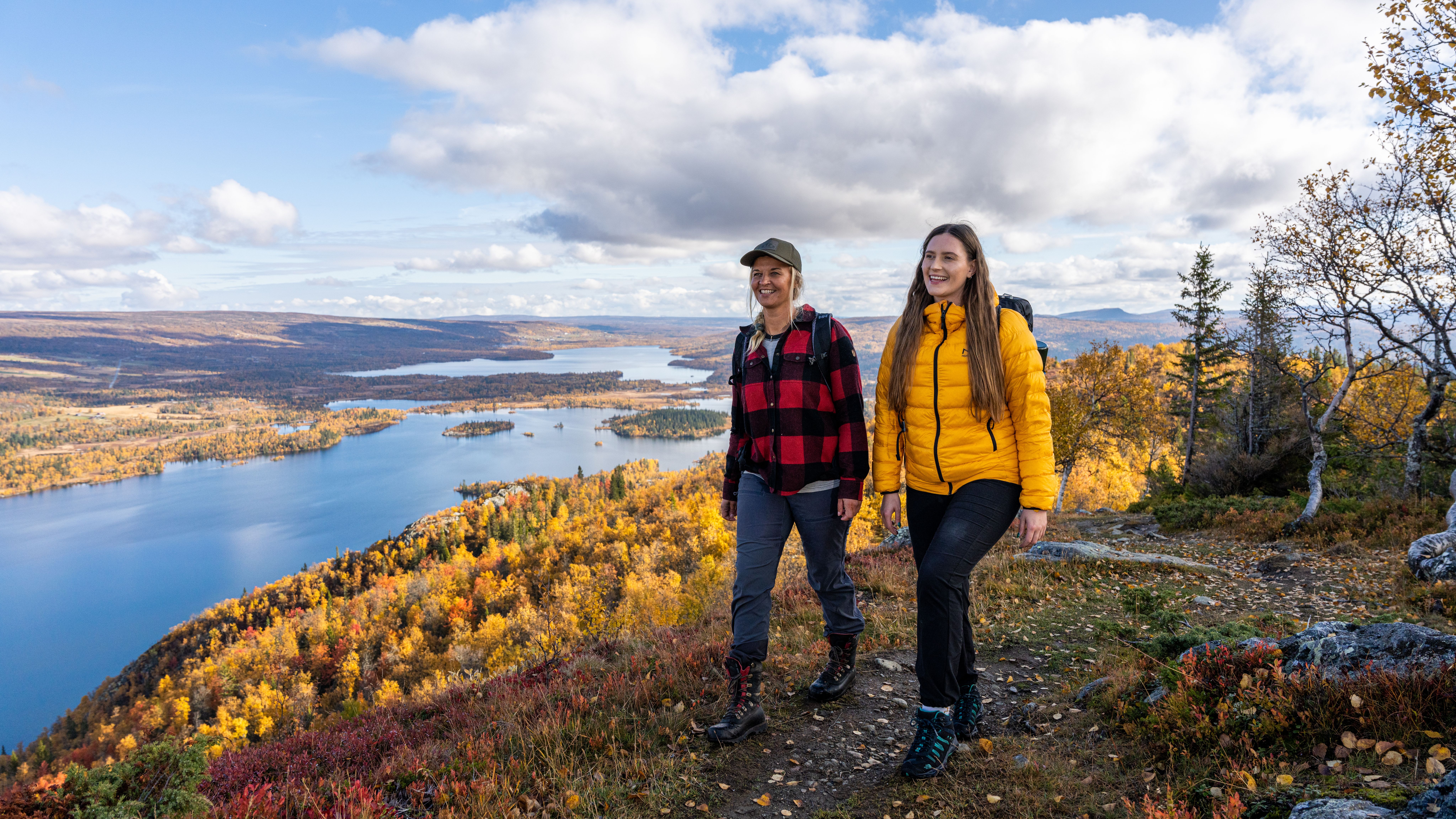 Two women are hiking to the top of a mountain in Hemsedal, Eastern Norway