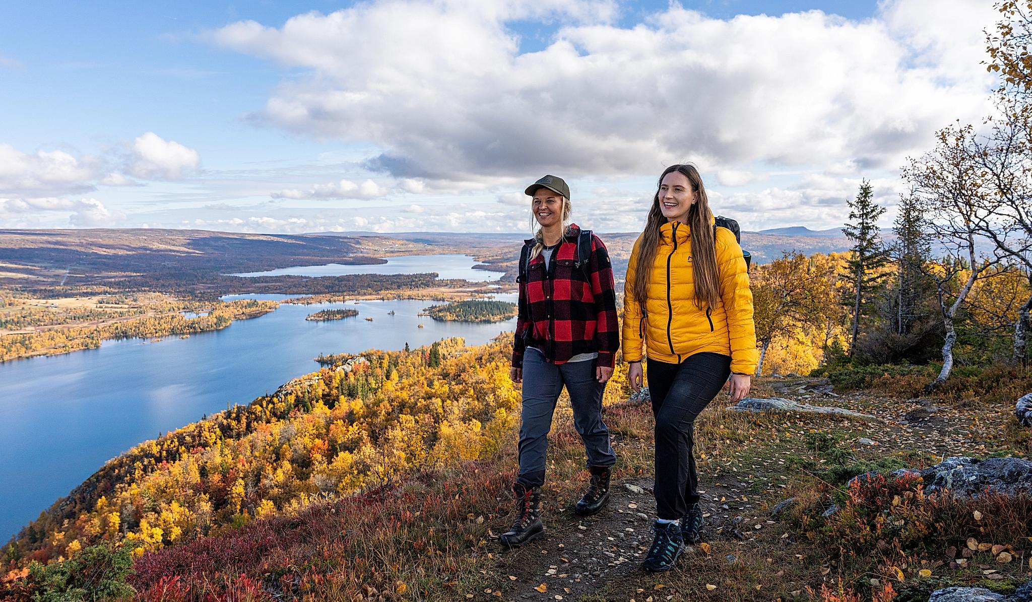 Two women are hiking to the top of a mountain in Hemsedal, Eastern Norway