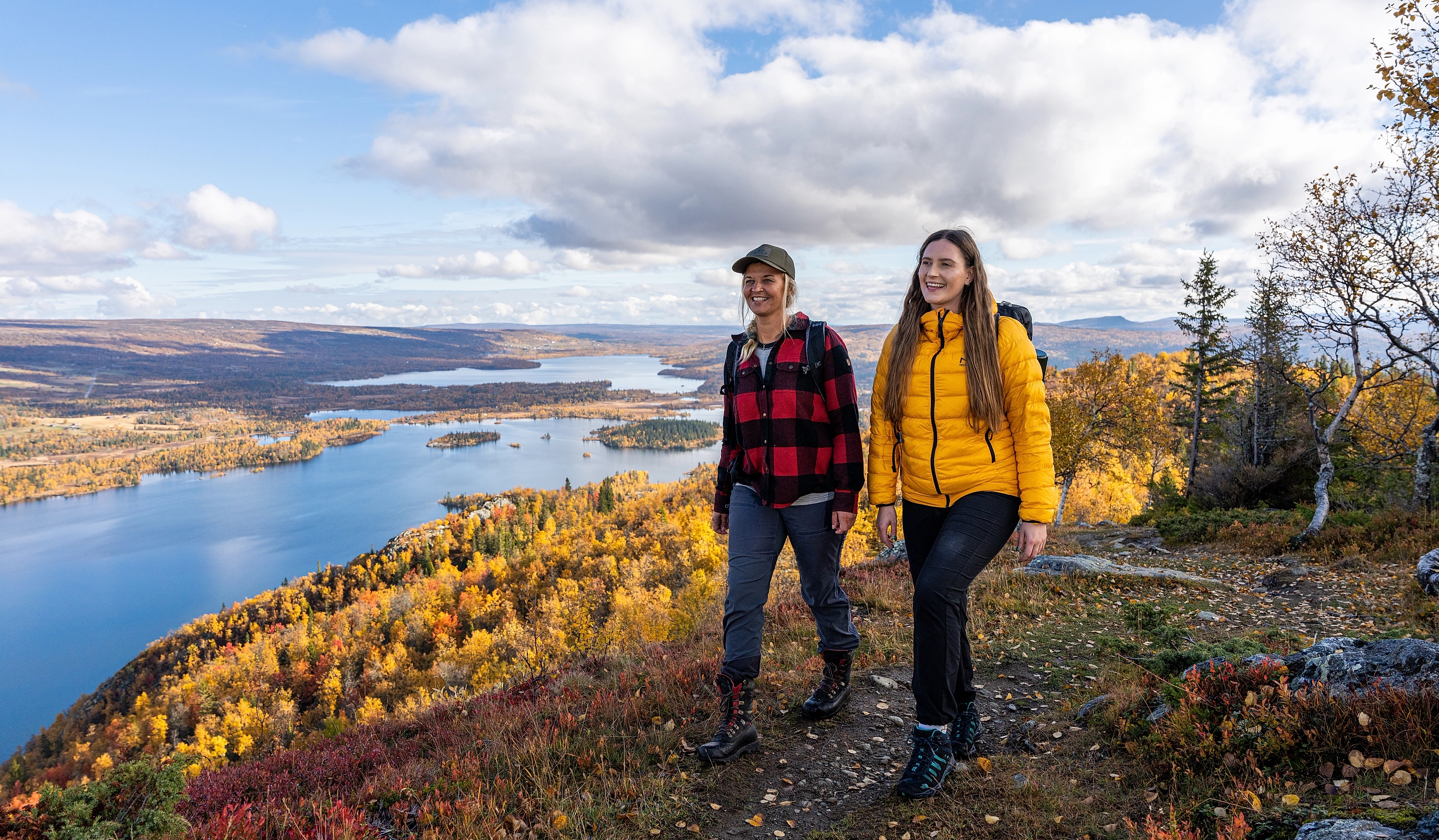 Two women are hiking to the top of a mountain in Hemsedal, Eastern Norway