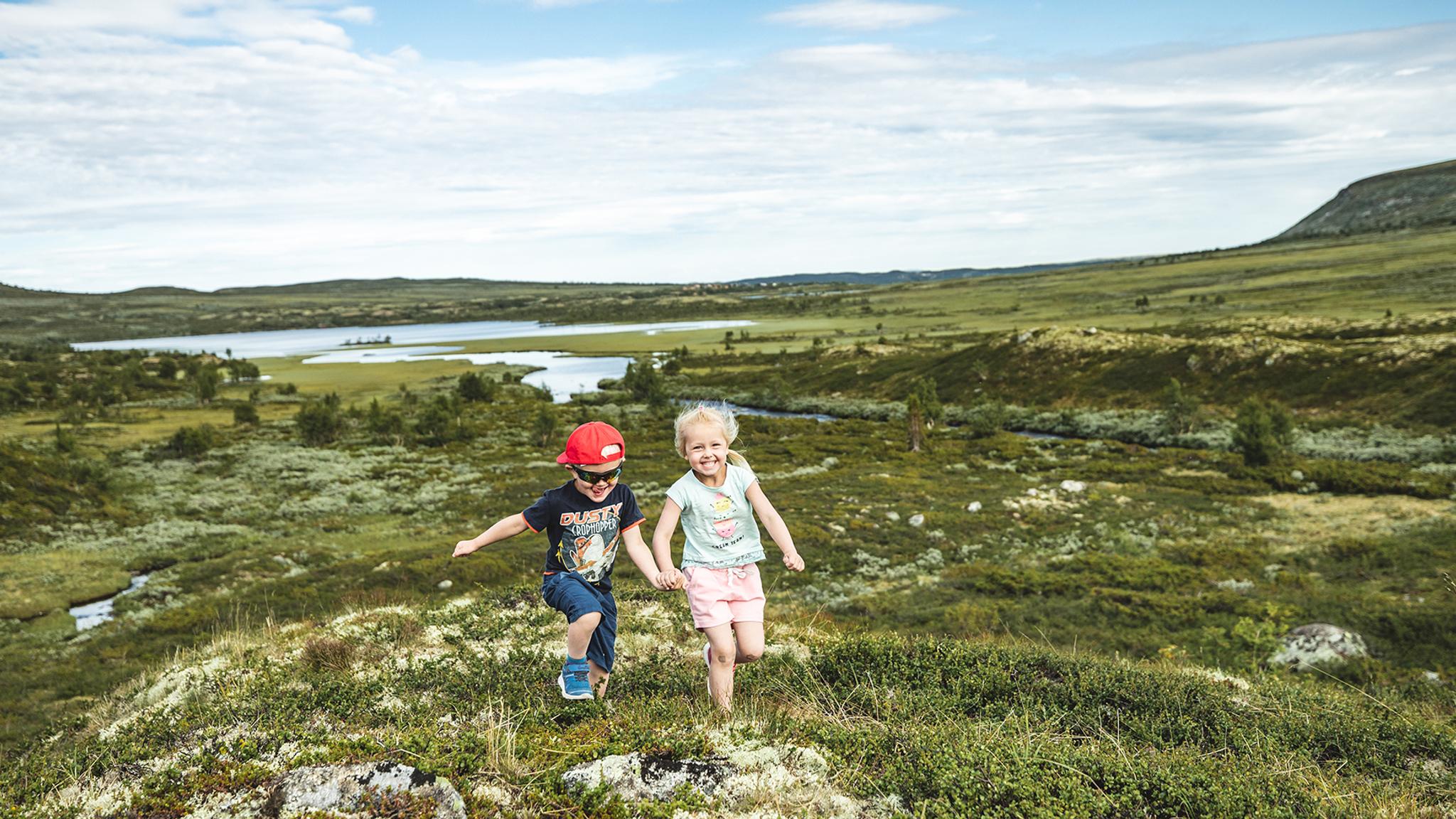 Two children are running in the mountains of Hallingdal, Eastern Norway