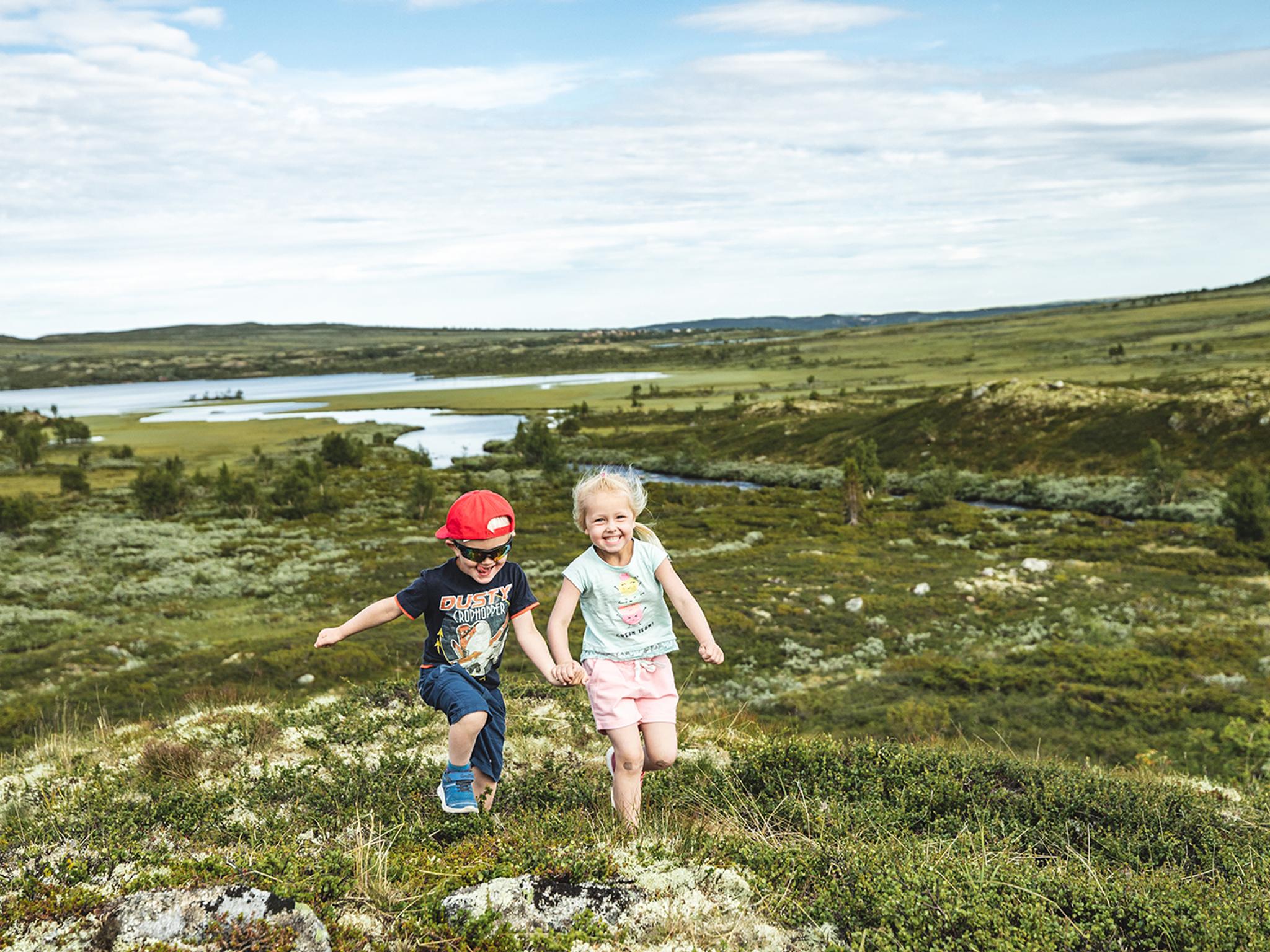 Two children are running in the mountains of Hallingdal, Eastern Norway