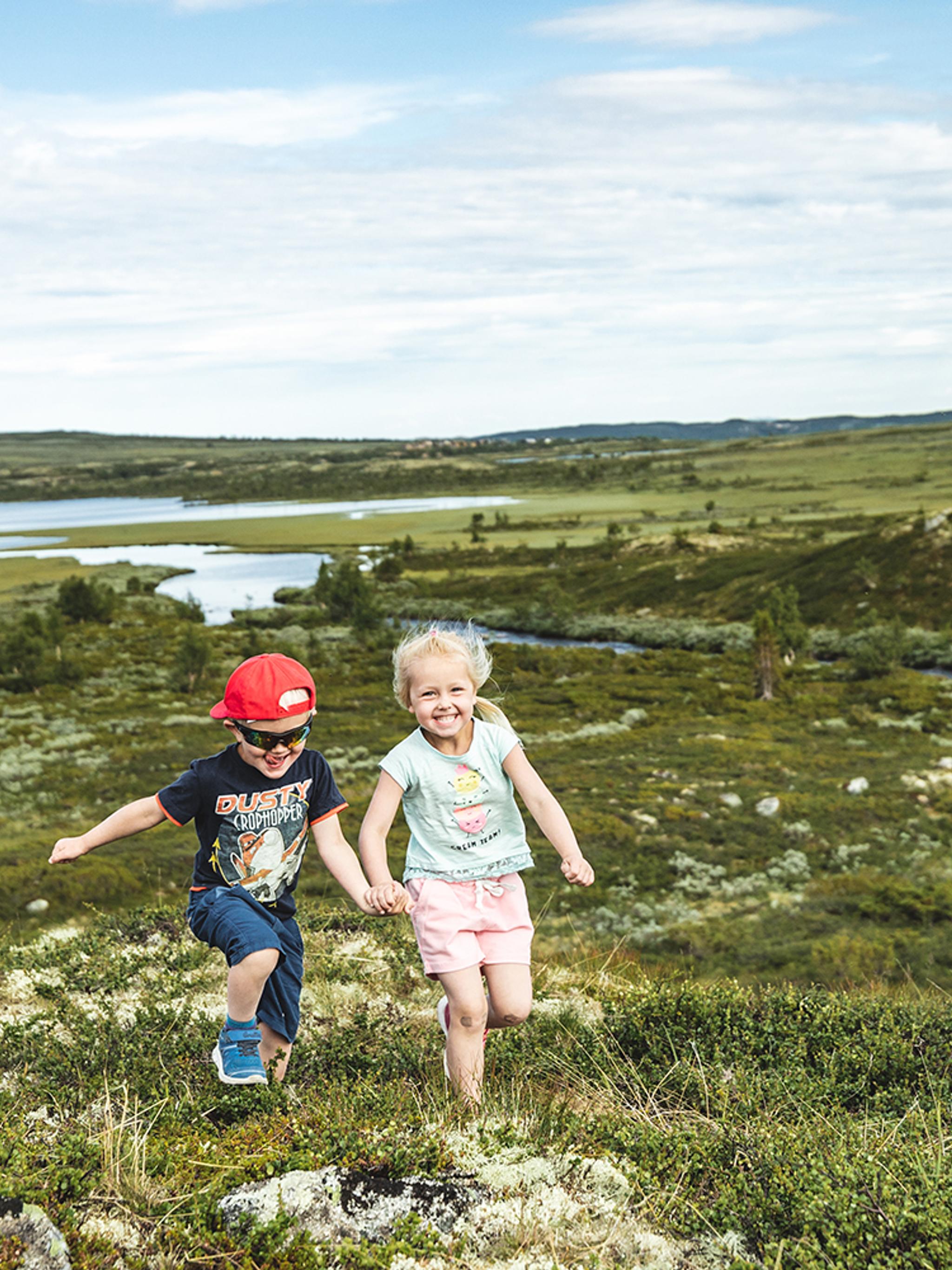 Two children are running in the mountains of Hallingdal, Eastern Norway