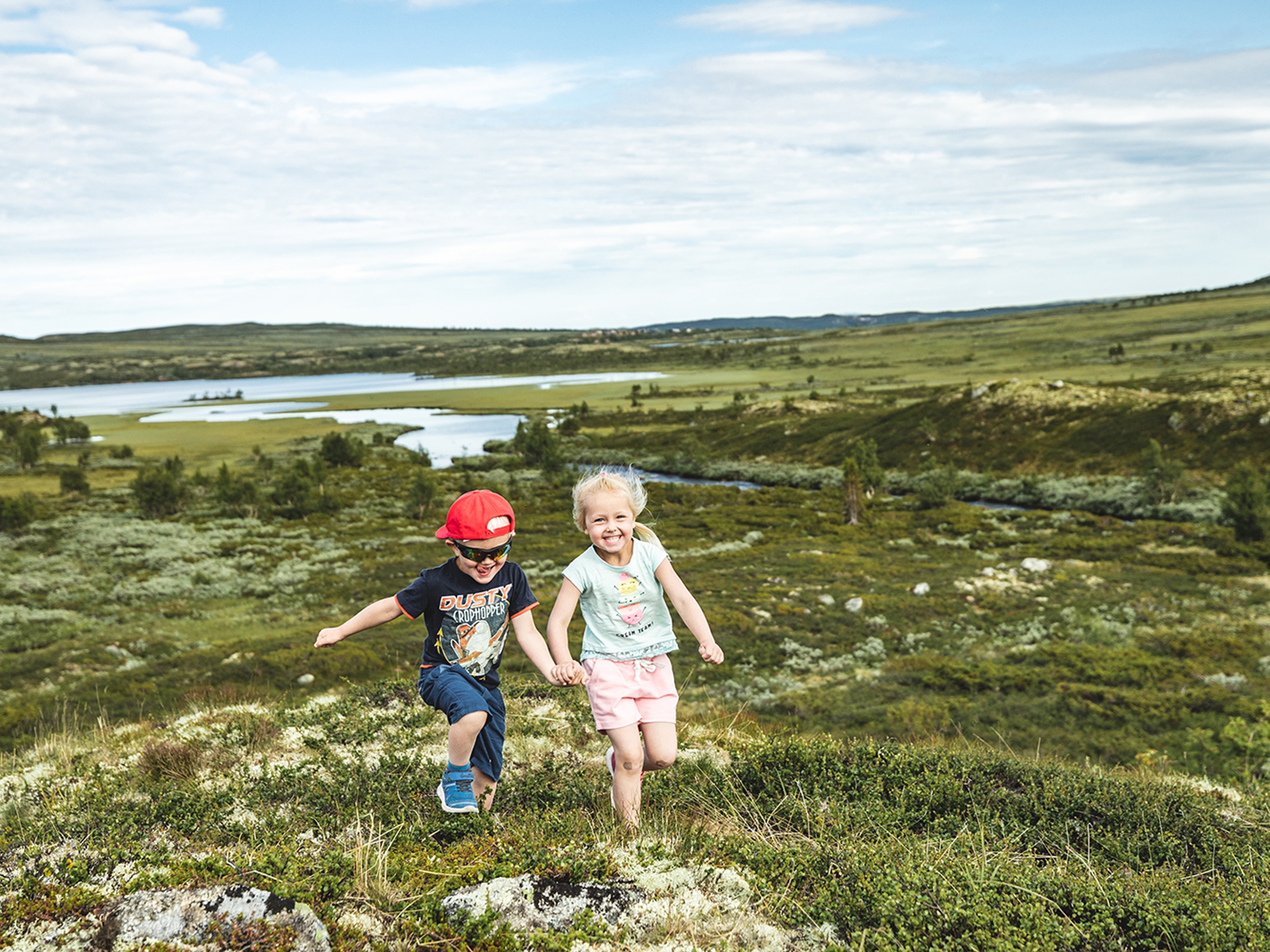 Two children are running in the mountains of Hallingdal, Eastern Norway