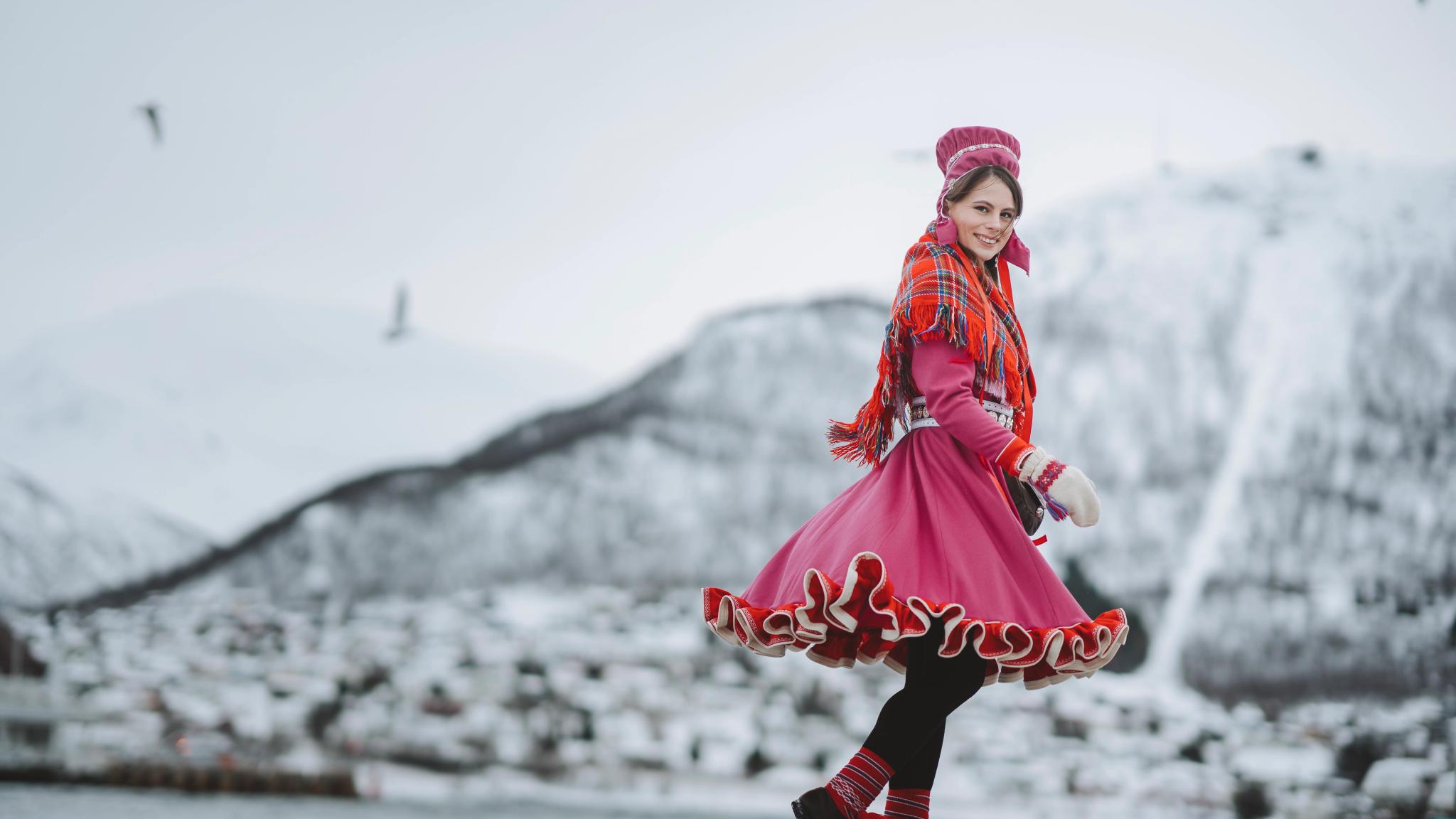 A woman is wearing traditional sami clothing in Tromsø, Northern Norway