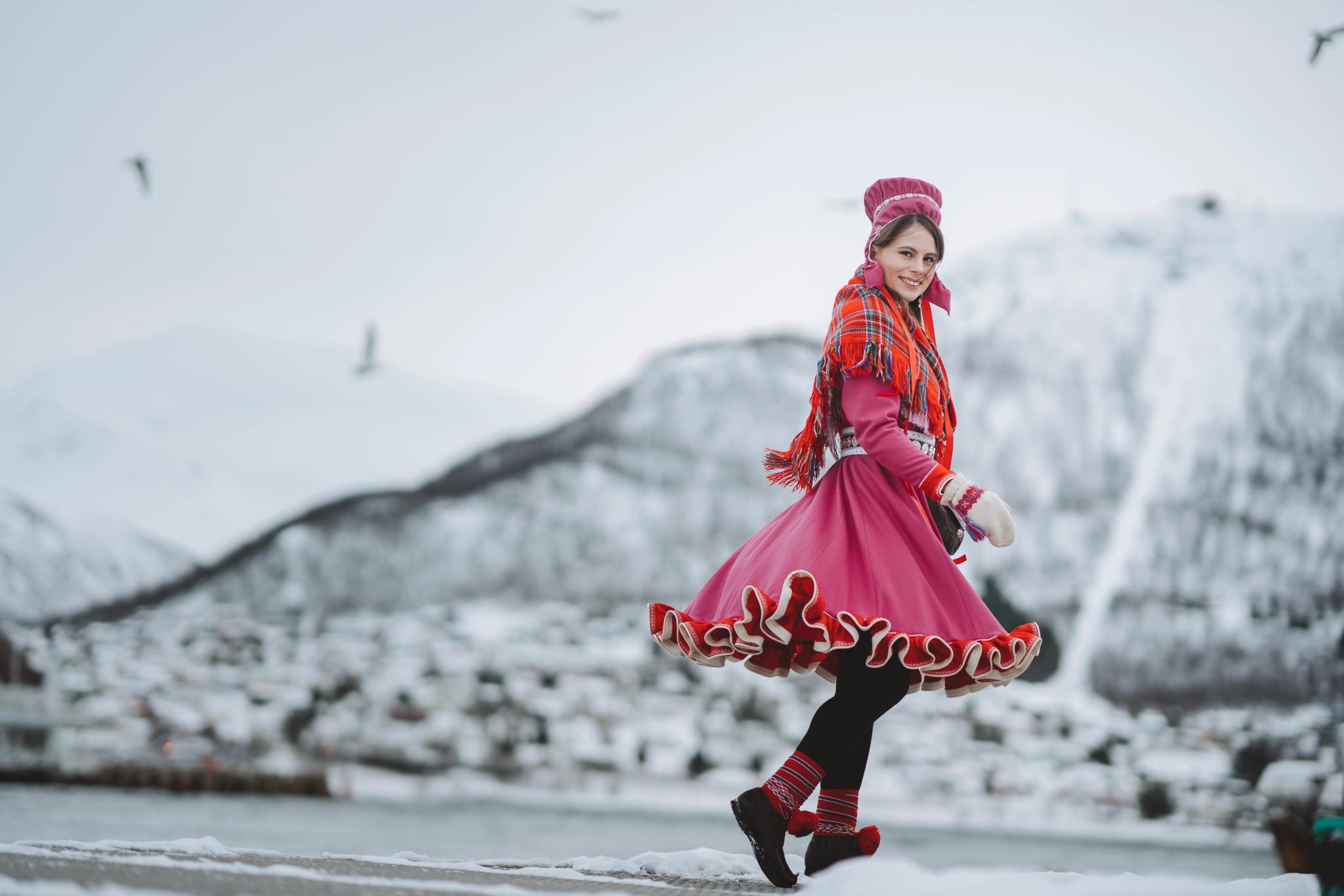 A woman is wearing traditional sami clothing in Tromsø, Northern Norway