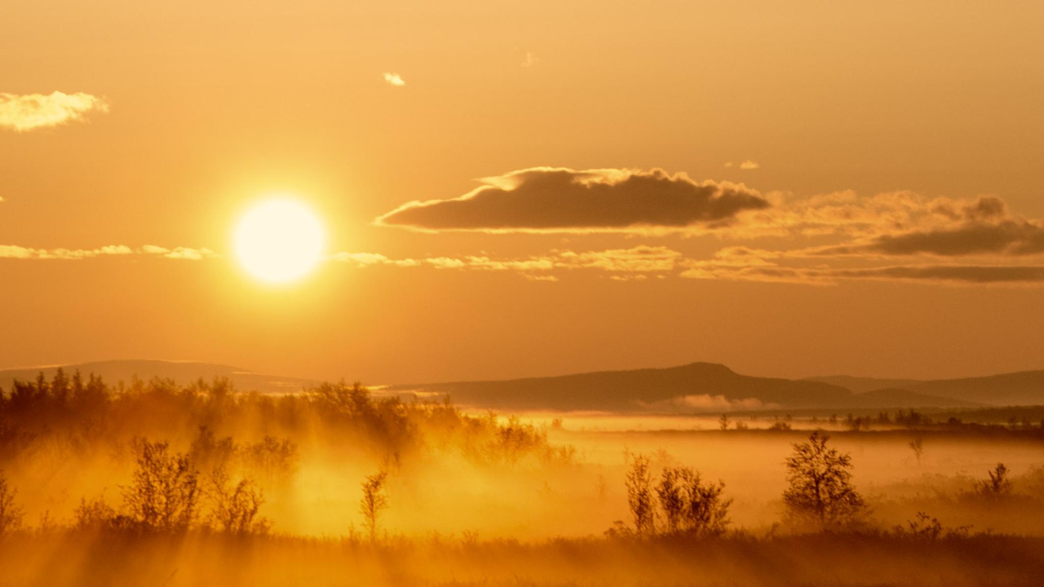 The midnight sun shining over the vast plains in Karasjok