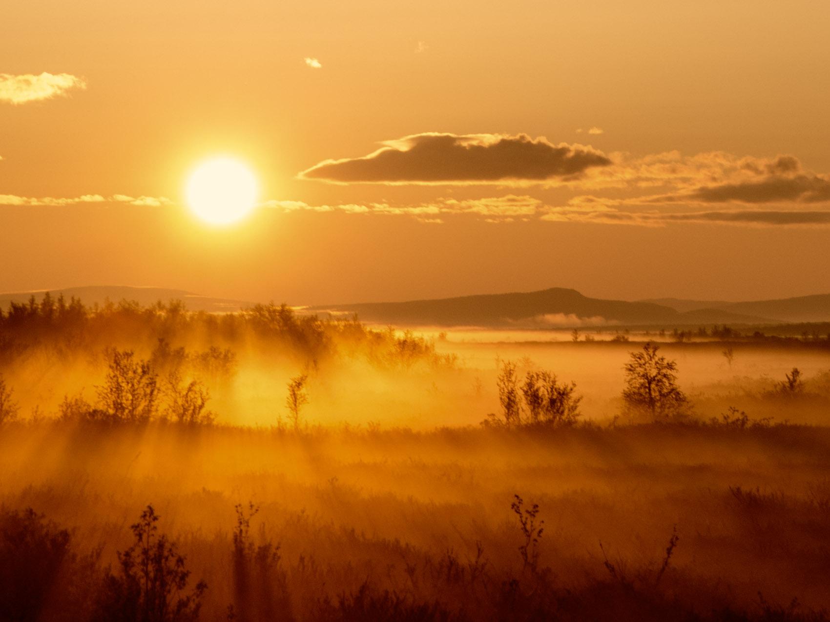 The midnight sun shining over the vast plains in Karasjok