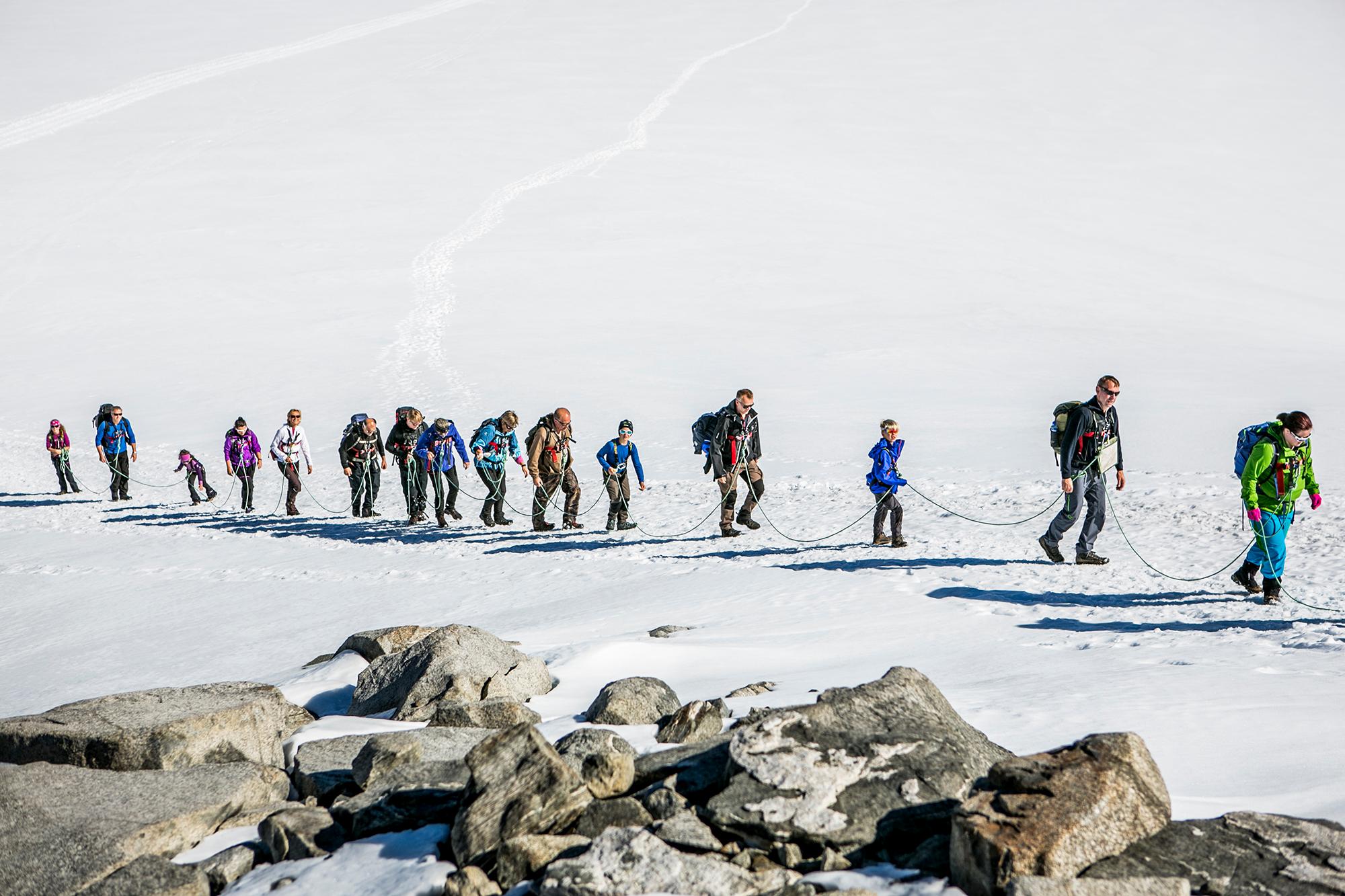 People strapped on to a safety-line on their way to Galdhøpiggen in Jotunheimen, Eastern Norway