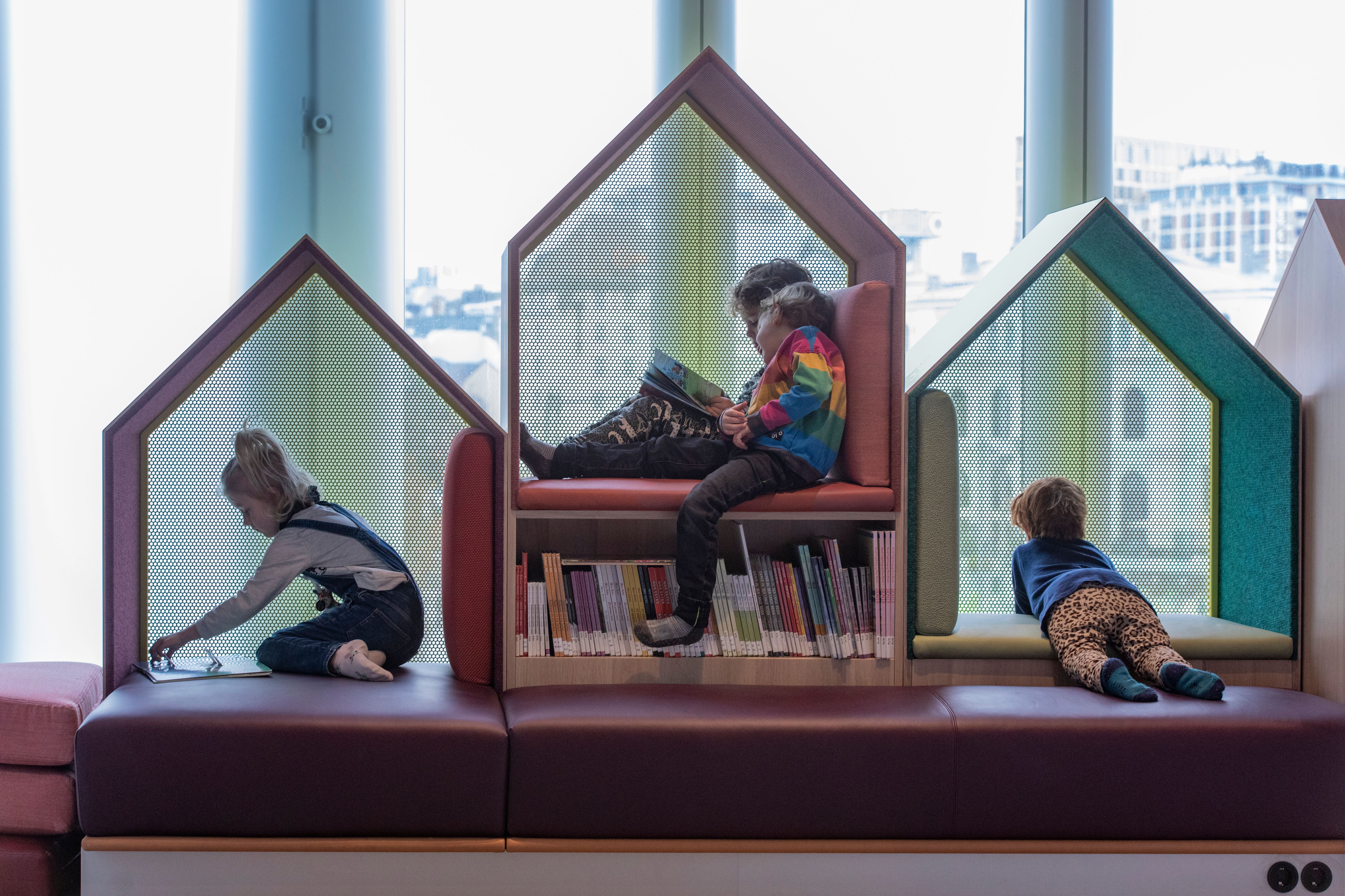 Children reading books at Deichman, public library in Bjørvika, Oslo.