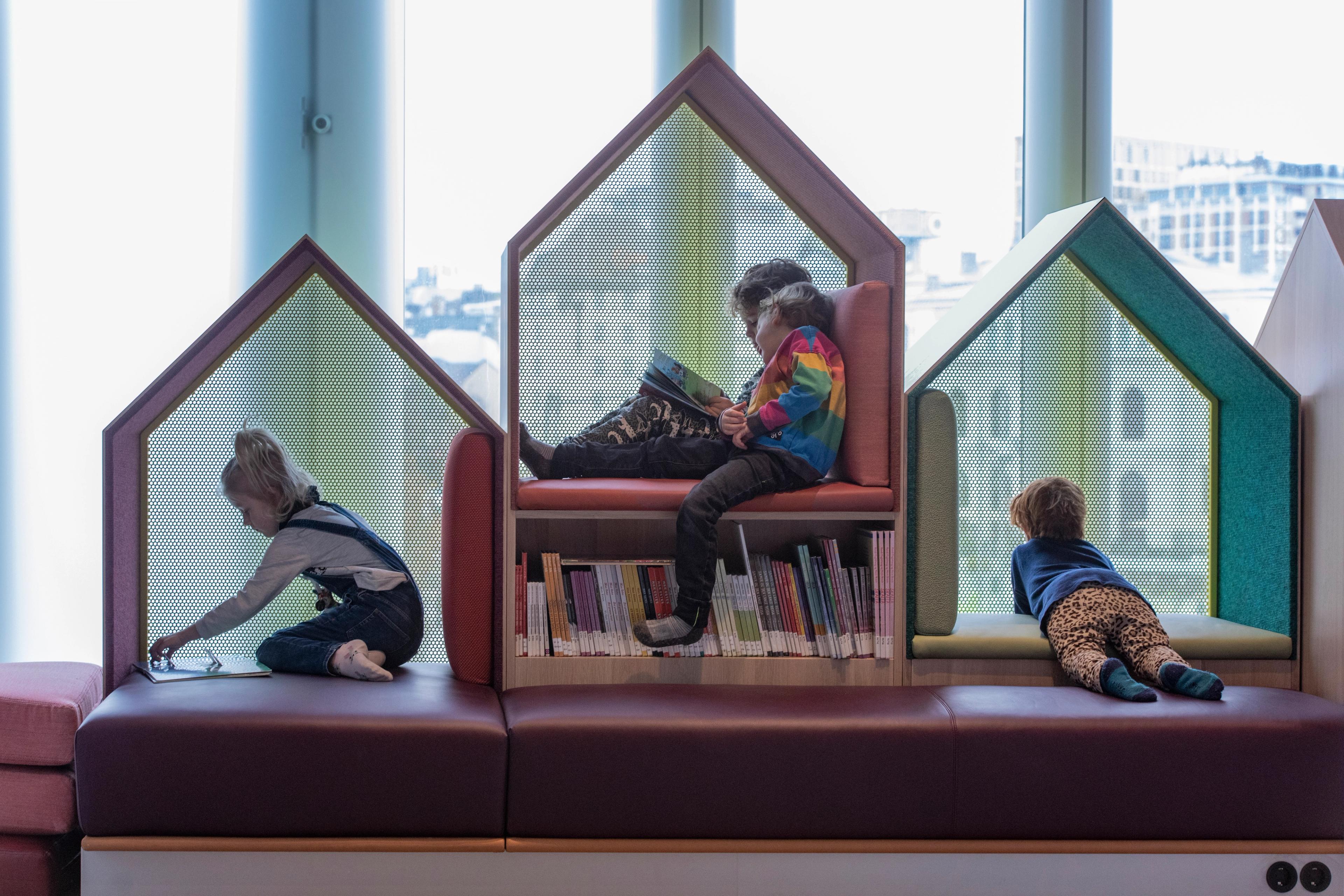 Children reading books at Deichman, public library in Bjørvika, Oslo.