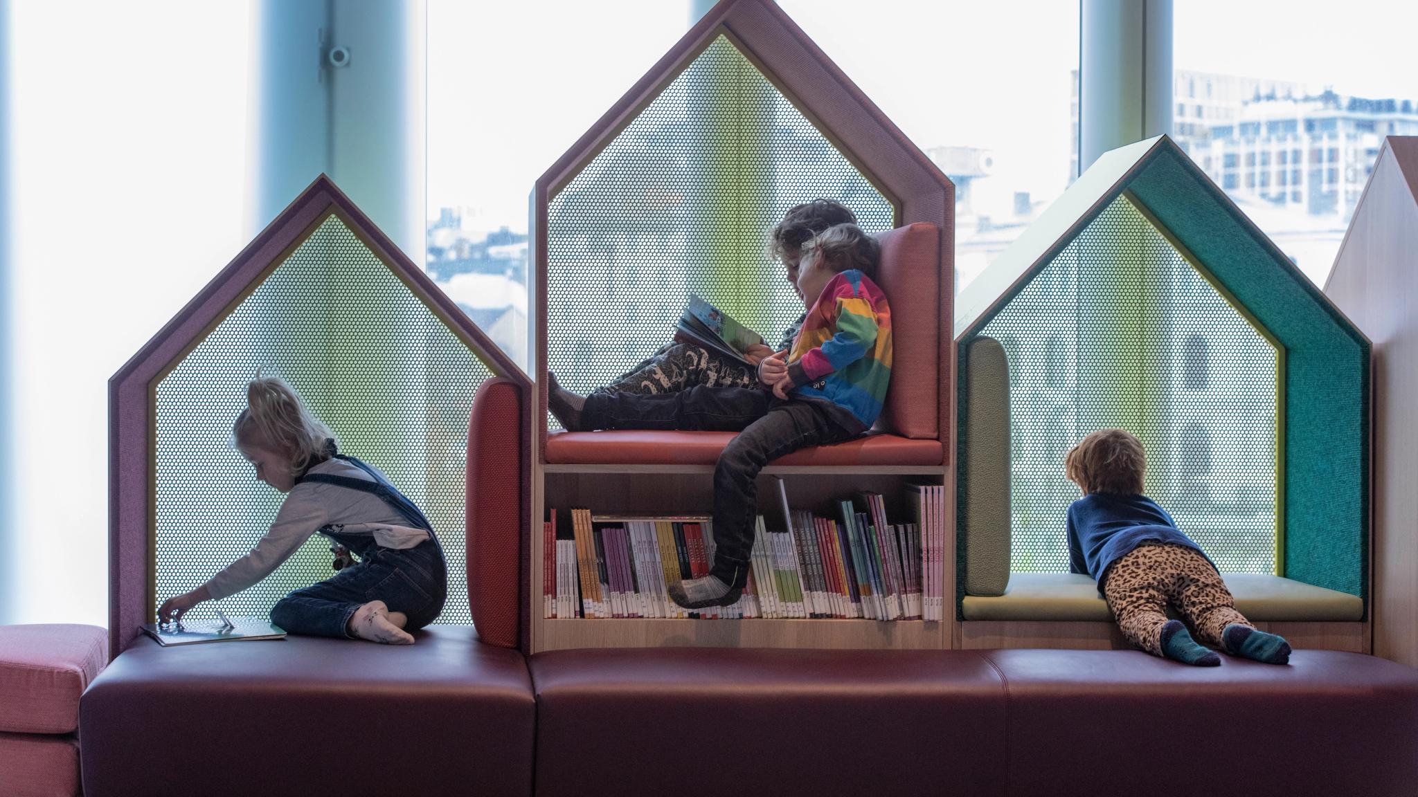 Children reading books at Deichman, public library in Bjørvika, Oslo.