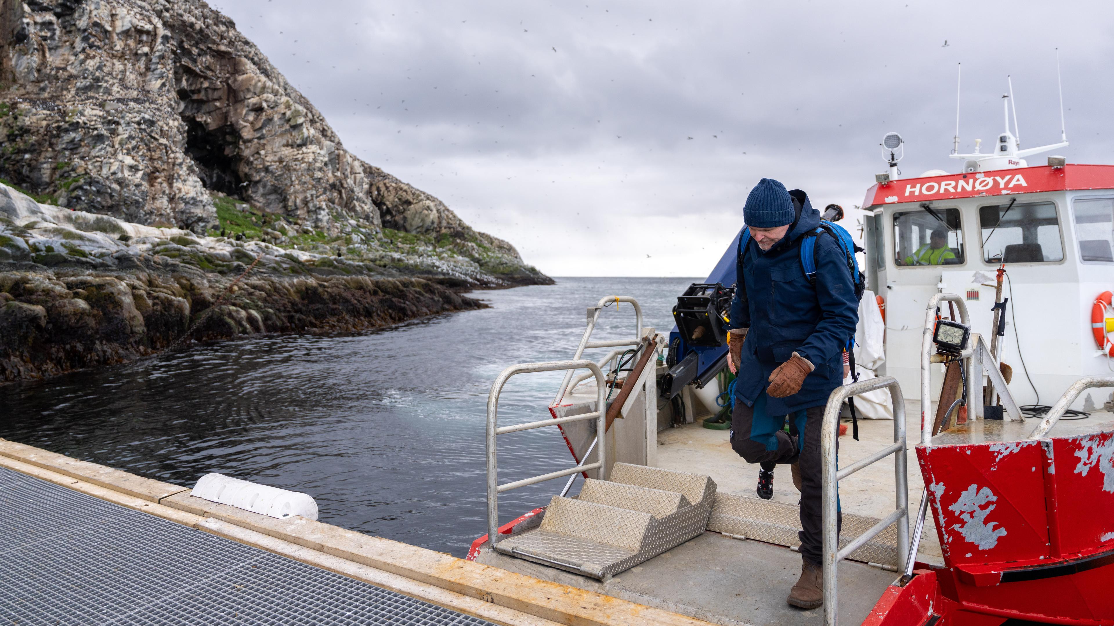 A man have taken a boat to go to Hornøya island outside of Vardø in Varanger, Northern Norway