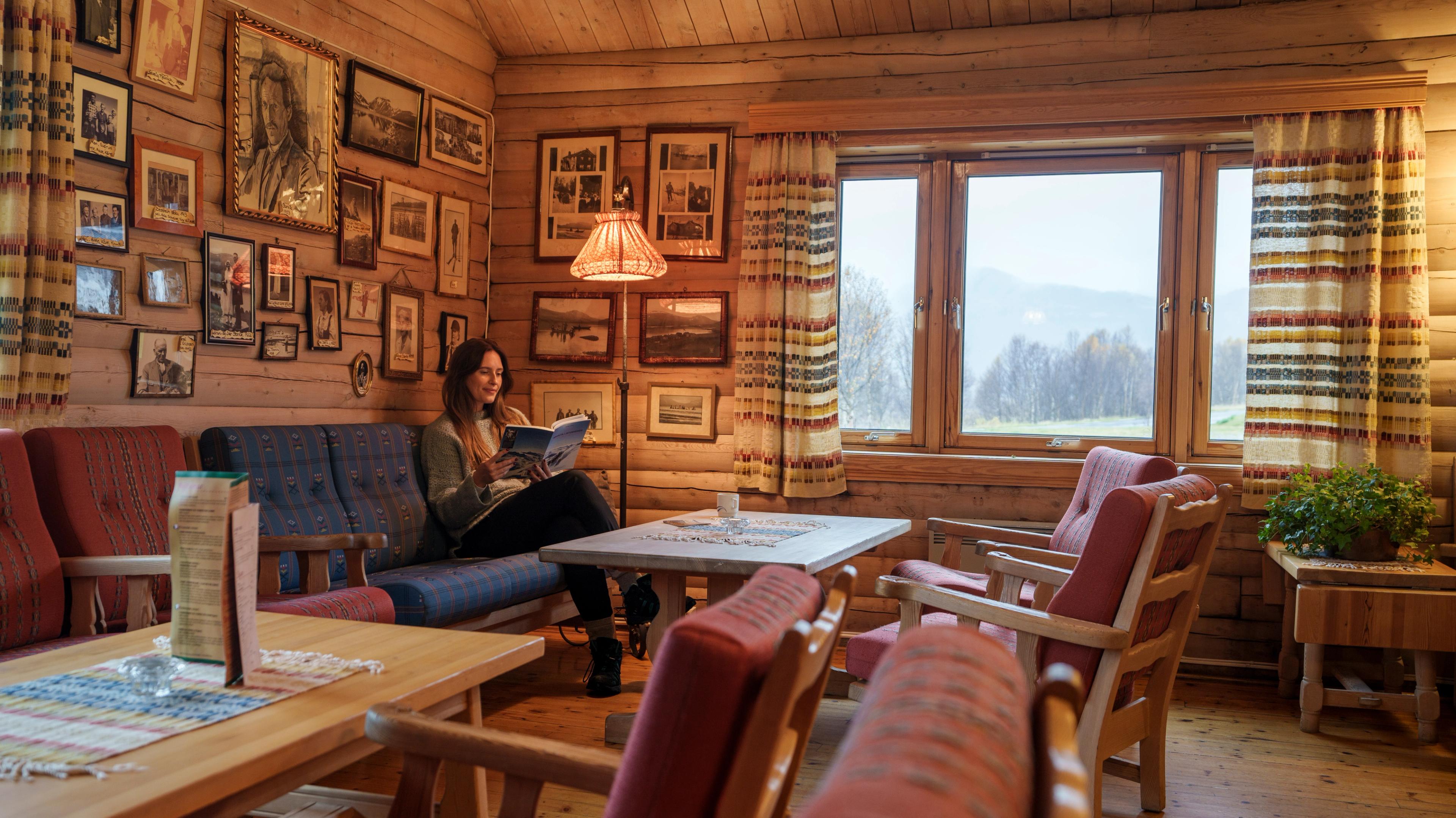 A woman reading a book at Bessheim Fjellstue