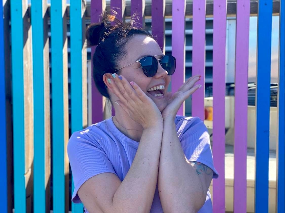 Majken Helén Evensen on front of a colorful wall