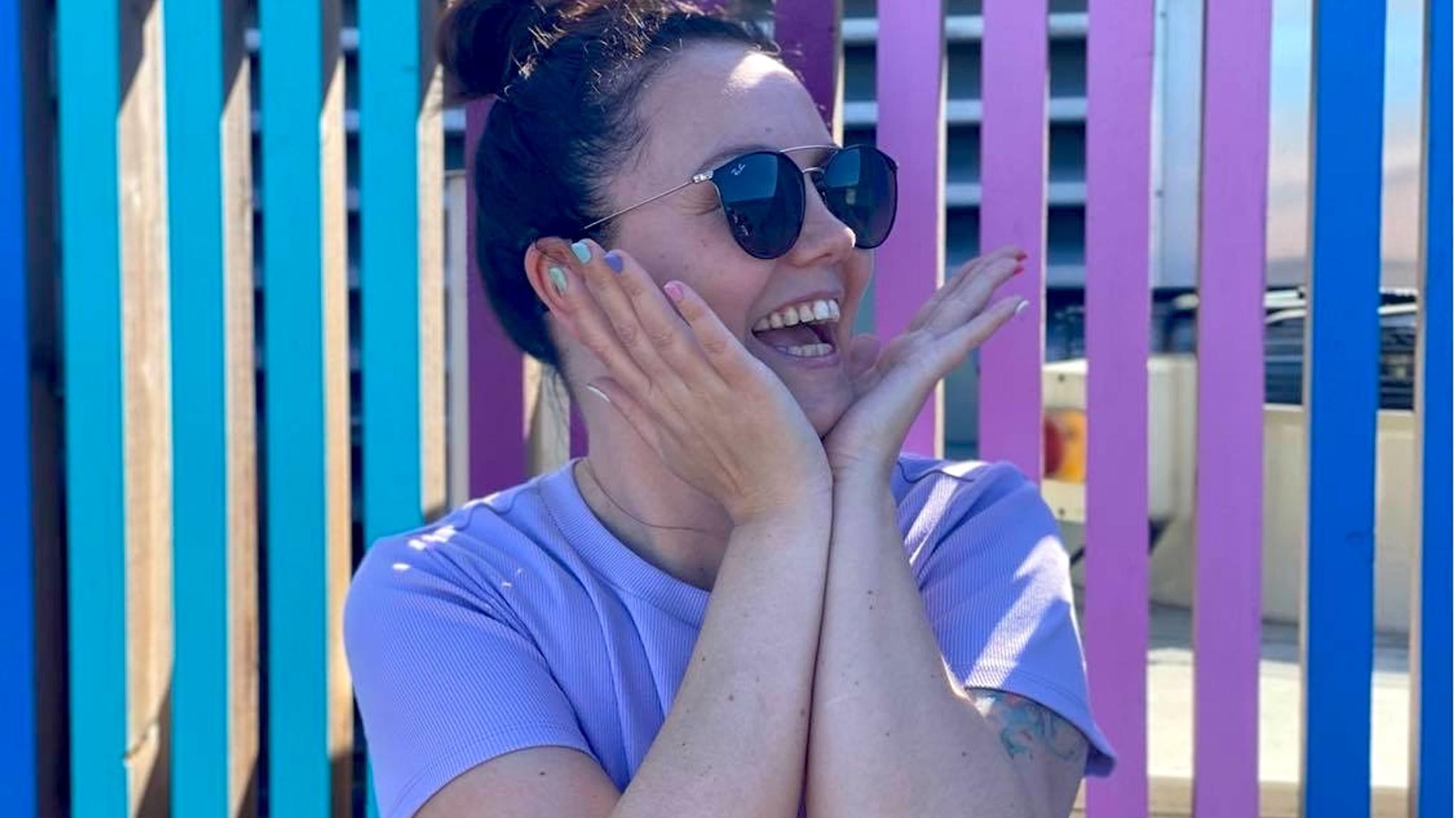 Majken Helén Evensen on front of a colorful wall