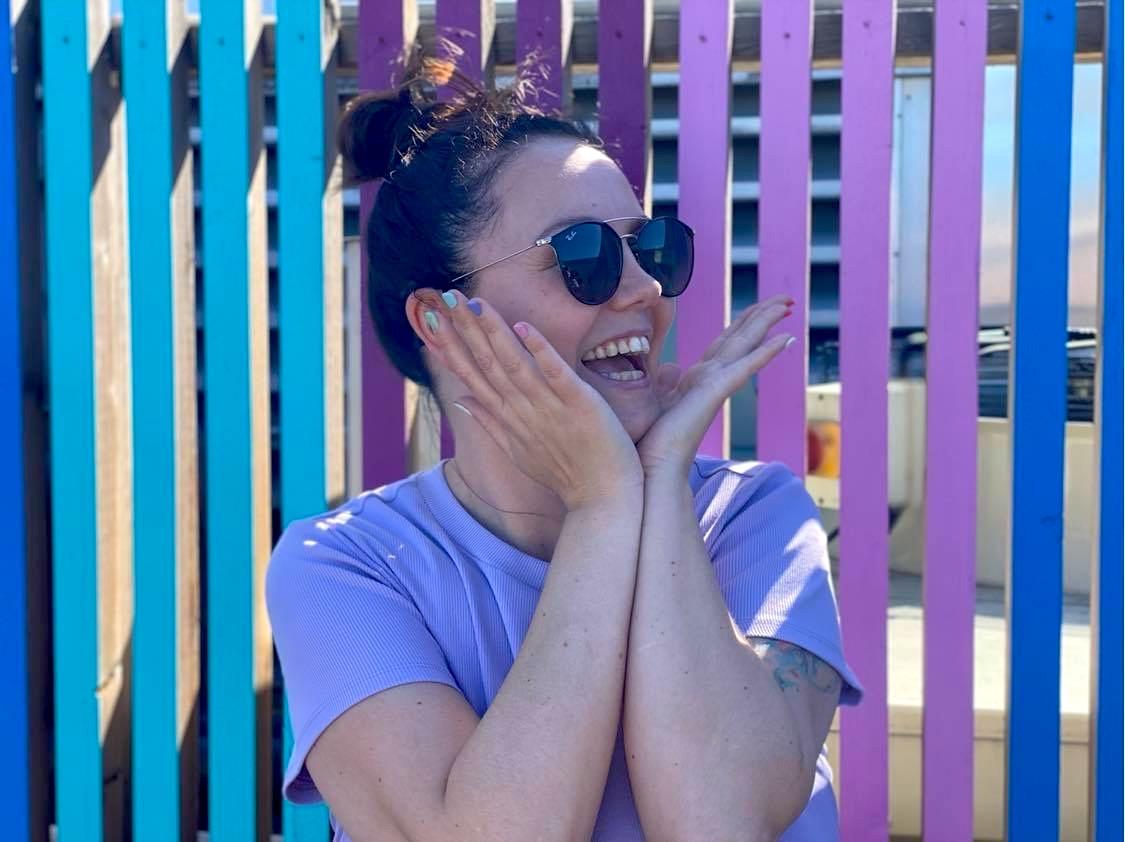 Majken Helén Evensen on front of a colorful wall