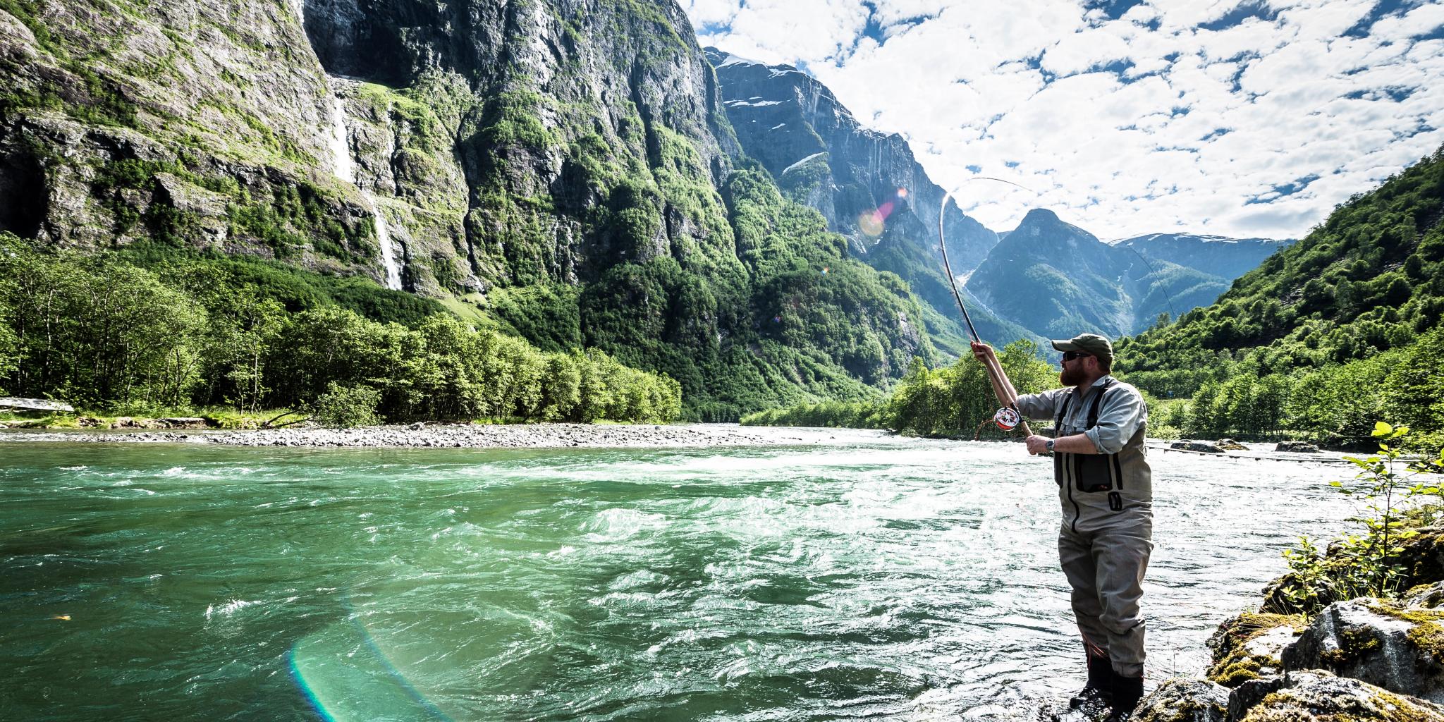 A man fishing for wild salmon in the Nærøydalselva in Fjord Norway