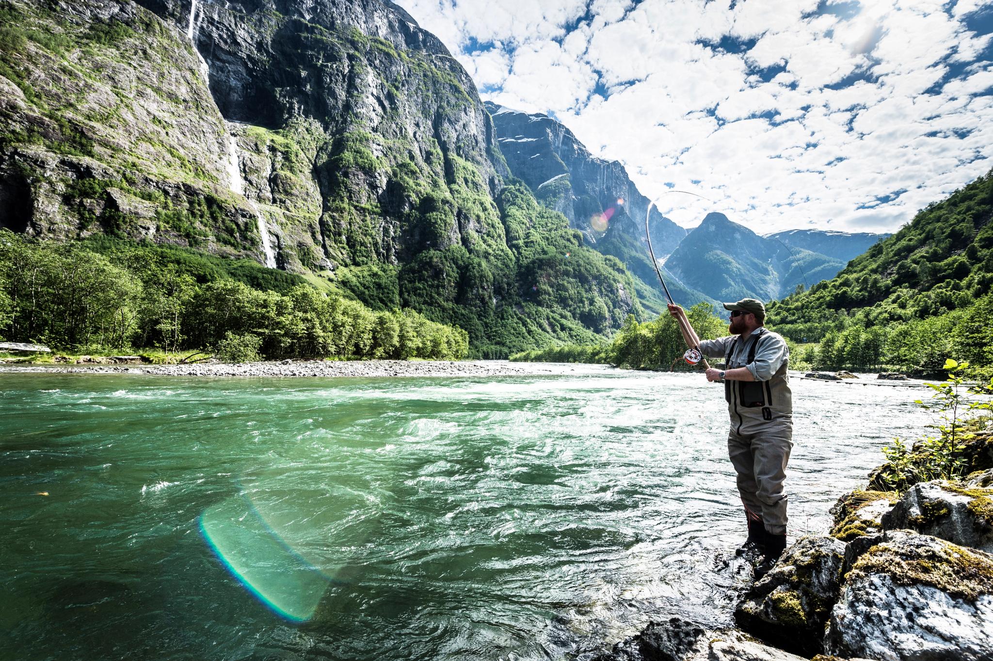 A man fishing for wild salmon in the Nærøydalselva river in Sogn og Fjordane