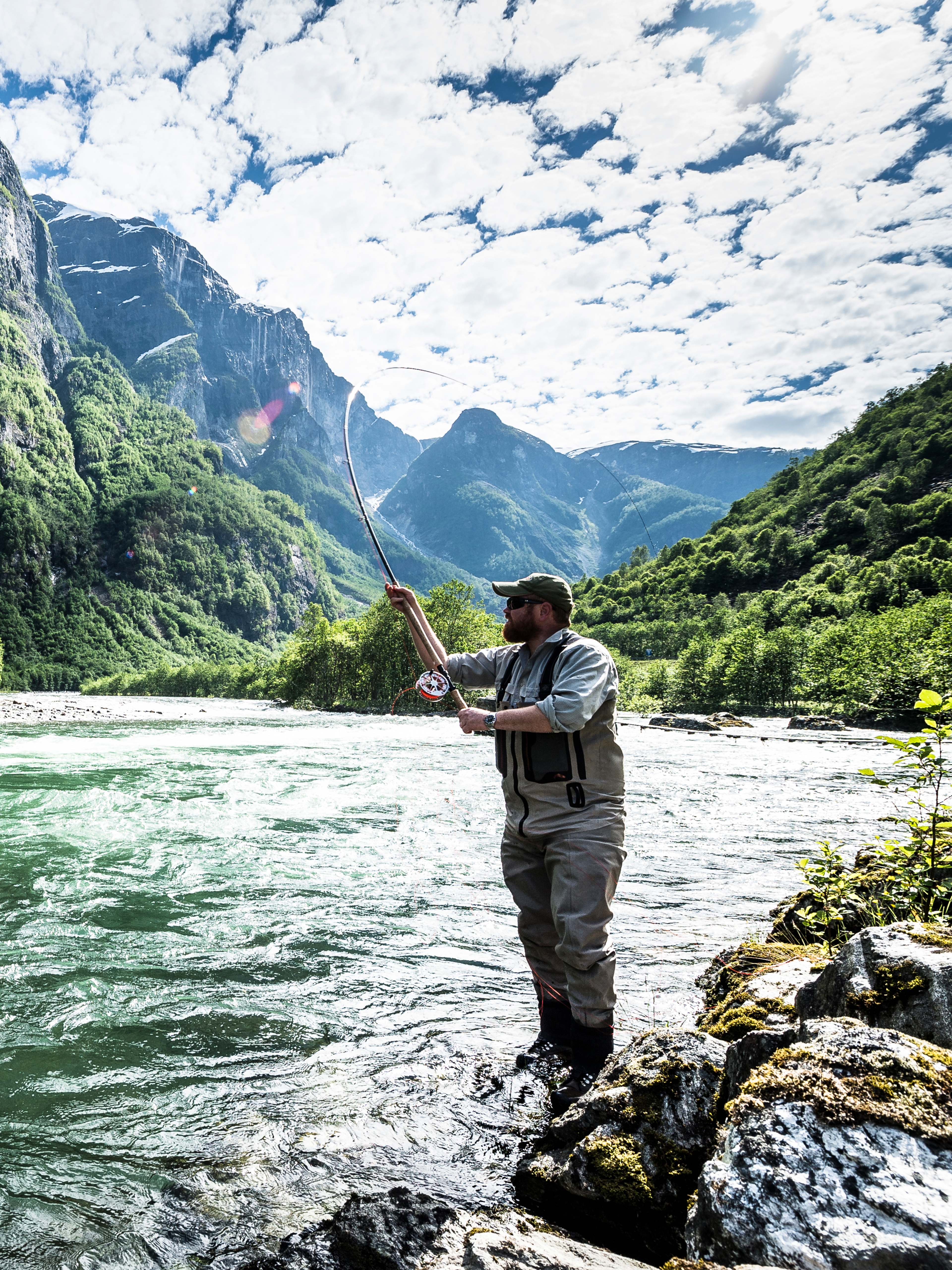 A man fishing for wild salmon in the Nærøydalselva in Fjord Norway