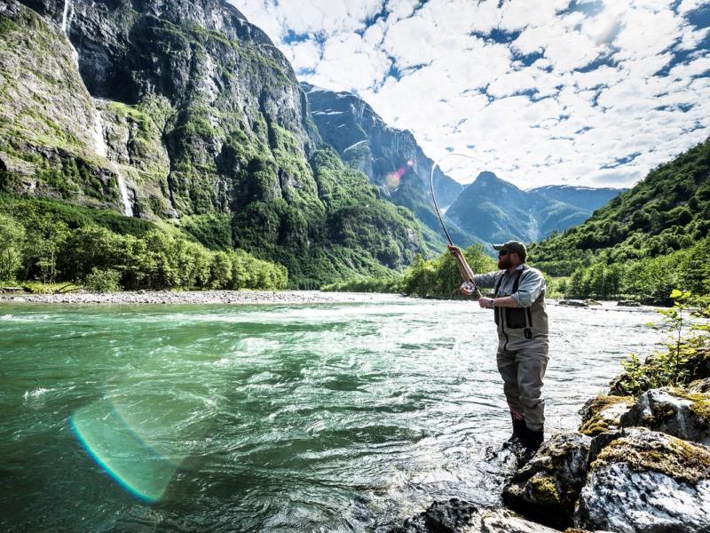 A man fishing for wild salmon in the Nærøydalselva in Fjord Norway