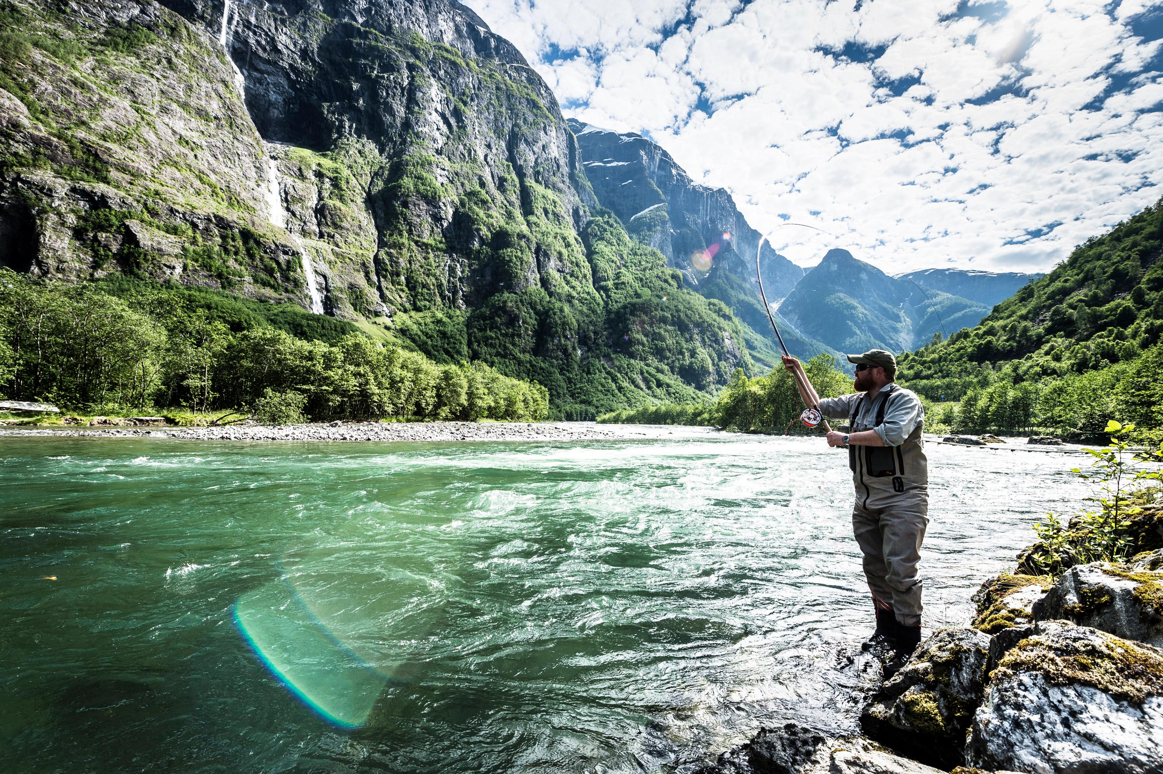 A man fishing for wild salmon in the Nærøydalselva river in Sogn og Fjordane