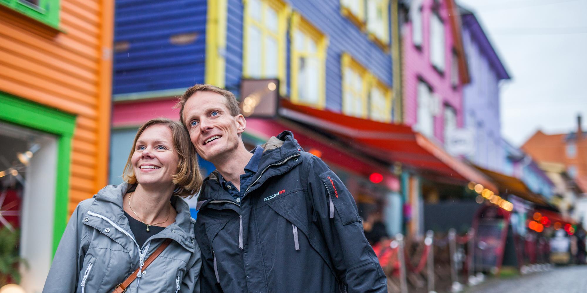 Two people on a weekend trip to Stavanger in Fjord Norway, in the colourful street Øvre Holmegate