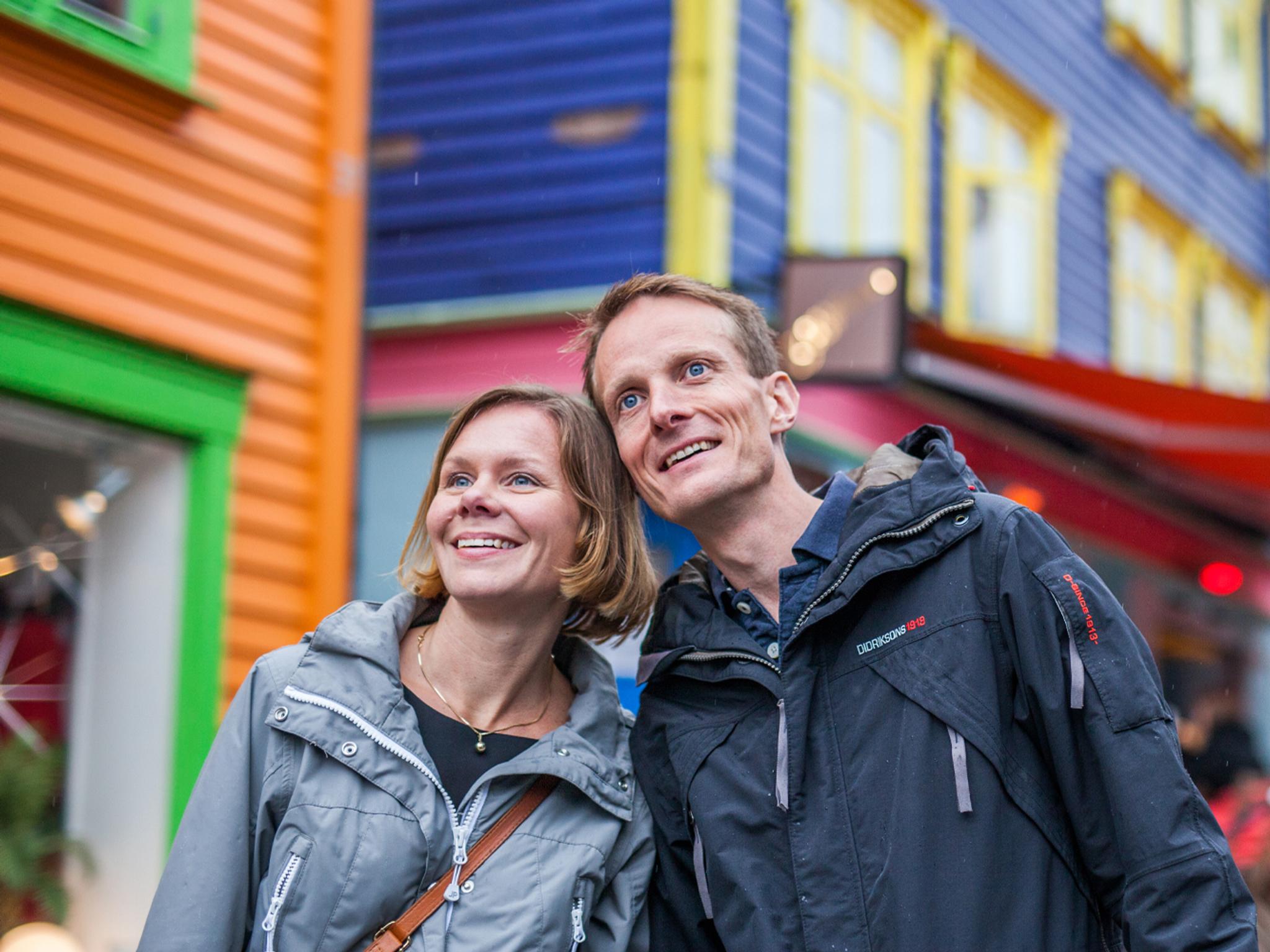 Two people on a weekend trip to Stavanger in Fjord Norway, in the colourful street Øvre Holmegate