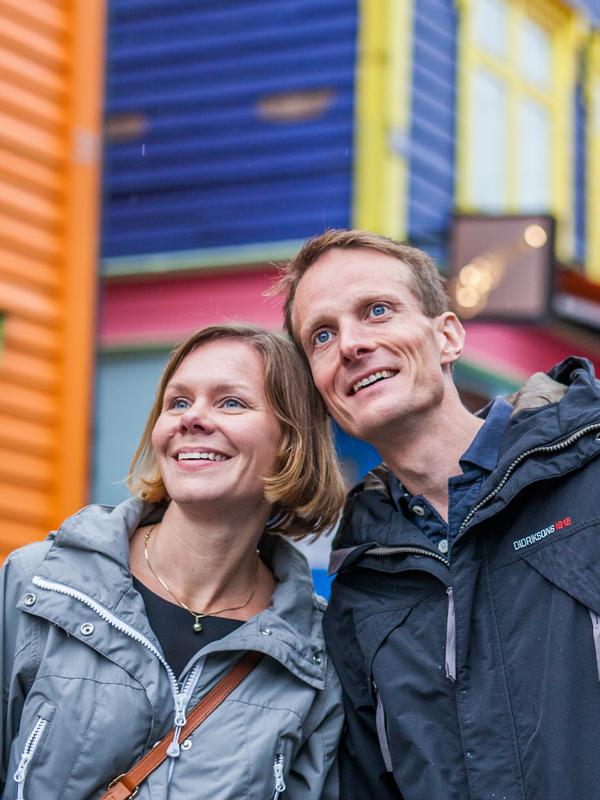 Two people on a weekend trip to Stavanger in Fjord Norway, in the colourful street Øvre Holmegate