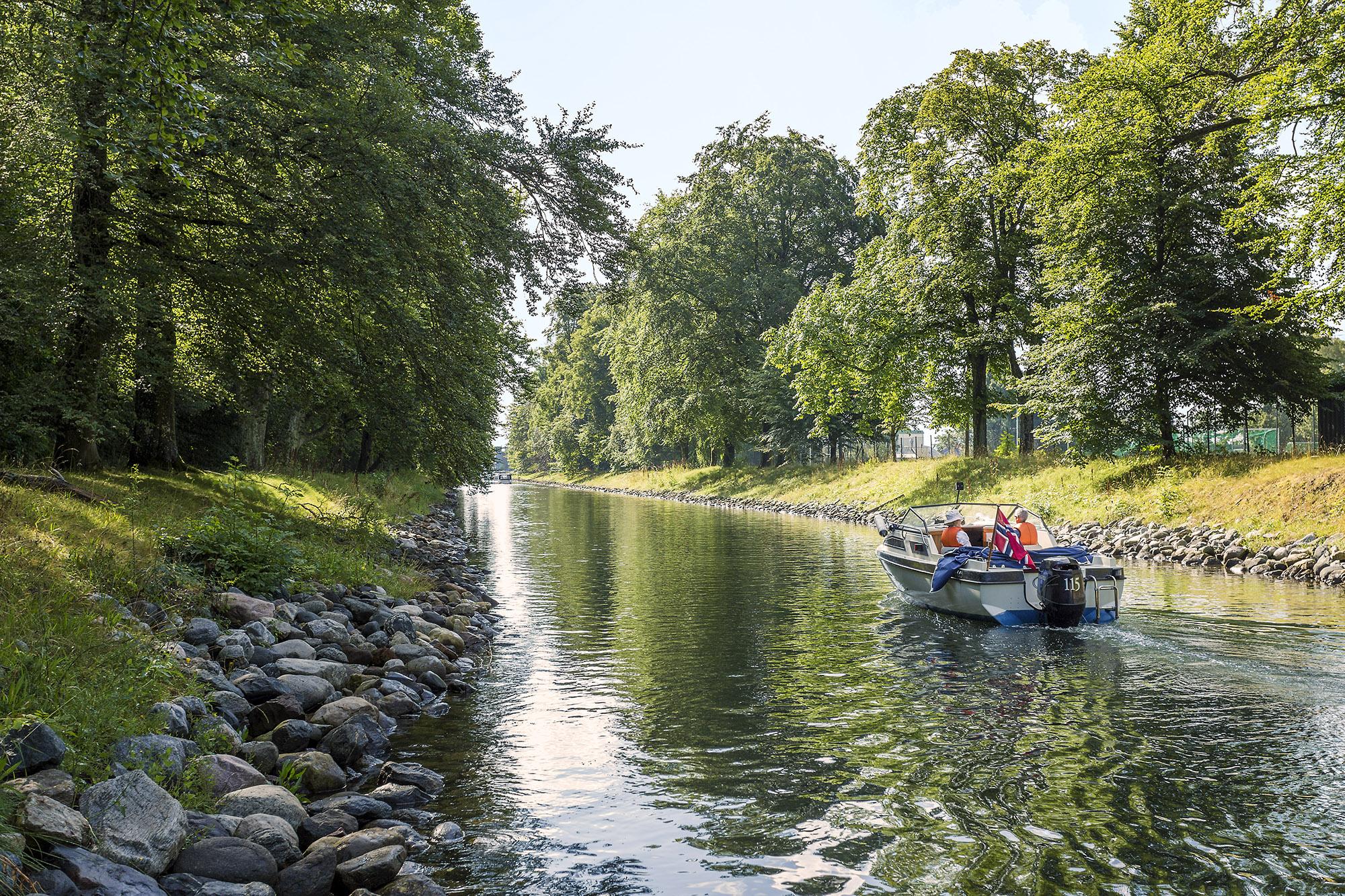 A boat drives in a leisurely pace in the Hortenkanalen canal in Horten in Vestfold, Eastern Norway