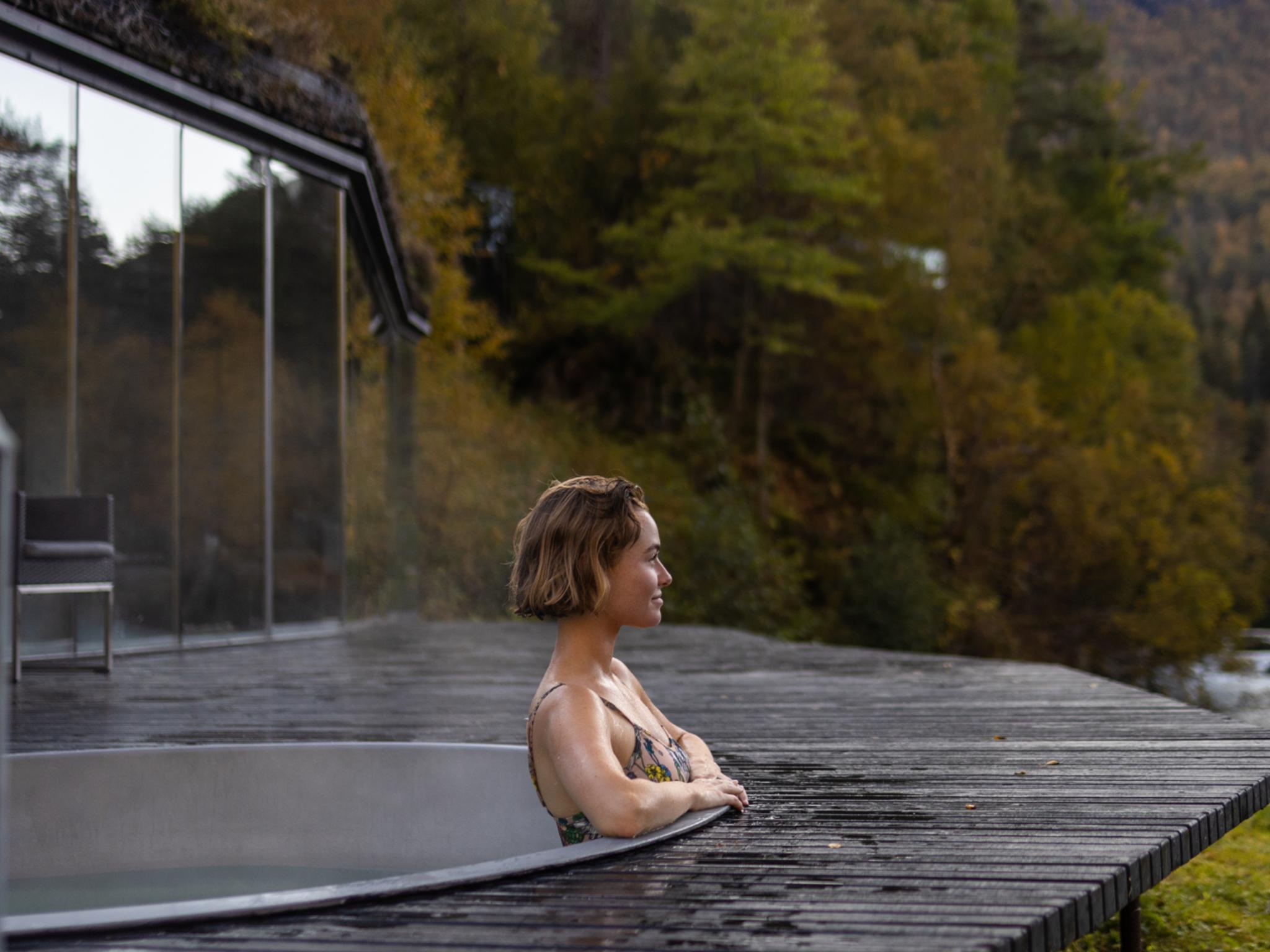 A women enjoying a bath in the spa area at Juvet Landskapshotell, Norway.