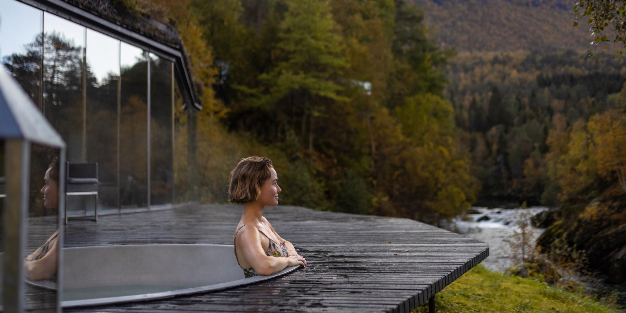 A women enjoying a bath in the spa area at Juvet Landskapshotell, Norway.