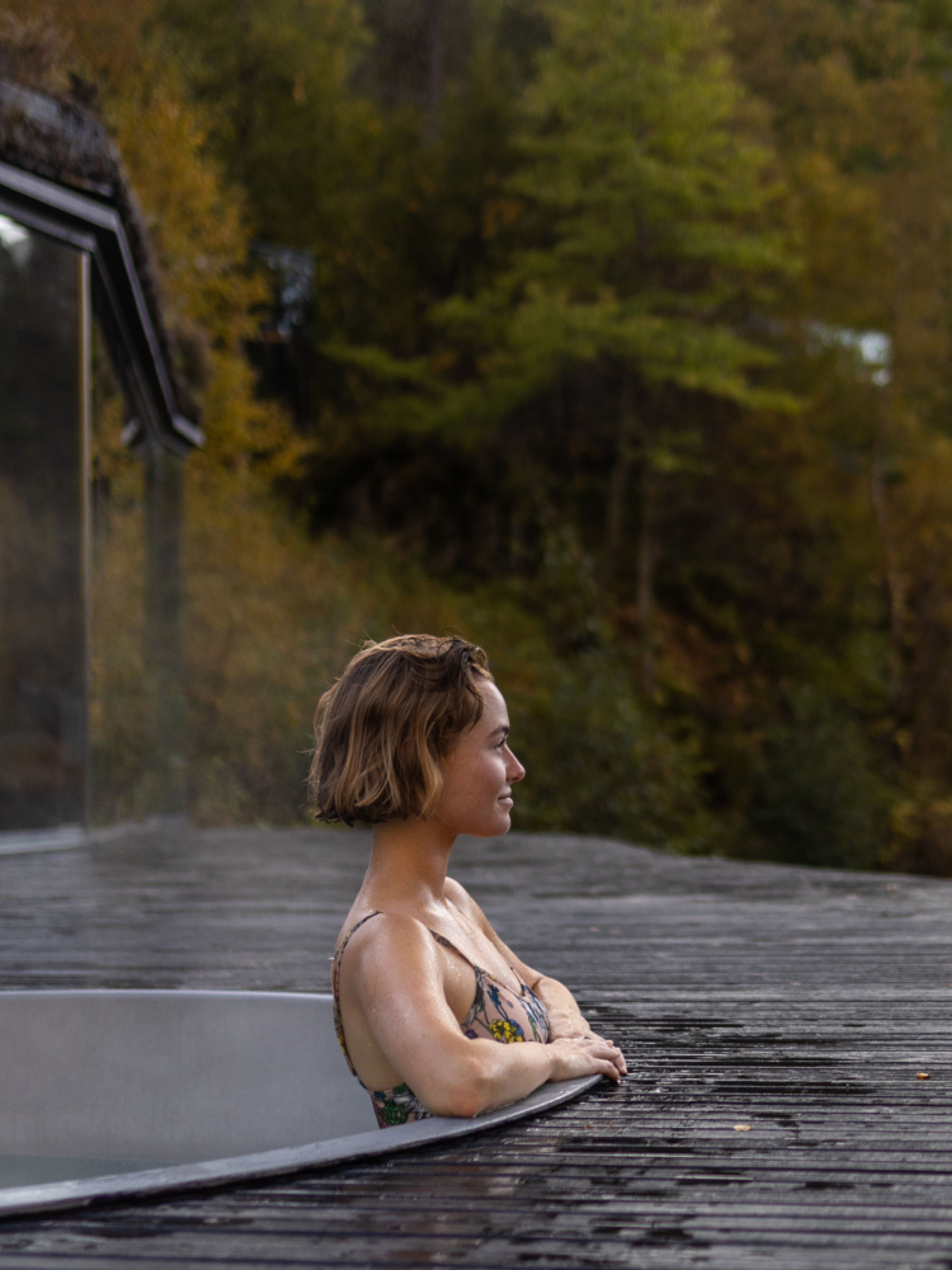 A women enjoying a bath in the spa area at Juvet Landskapshotell, Norway.