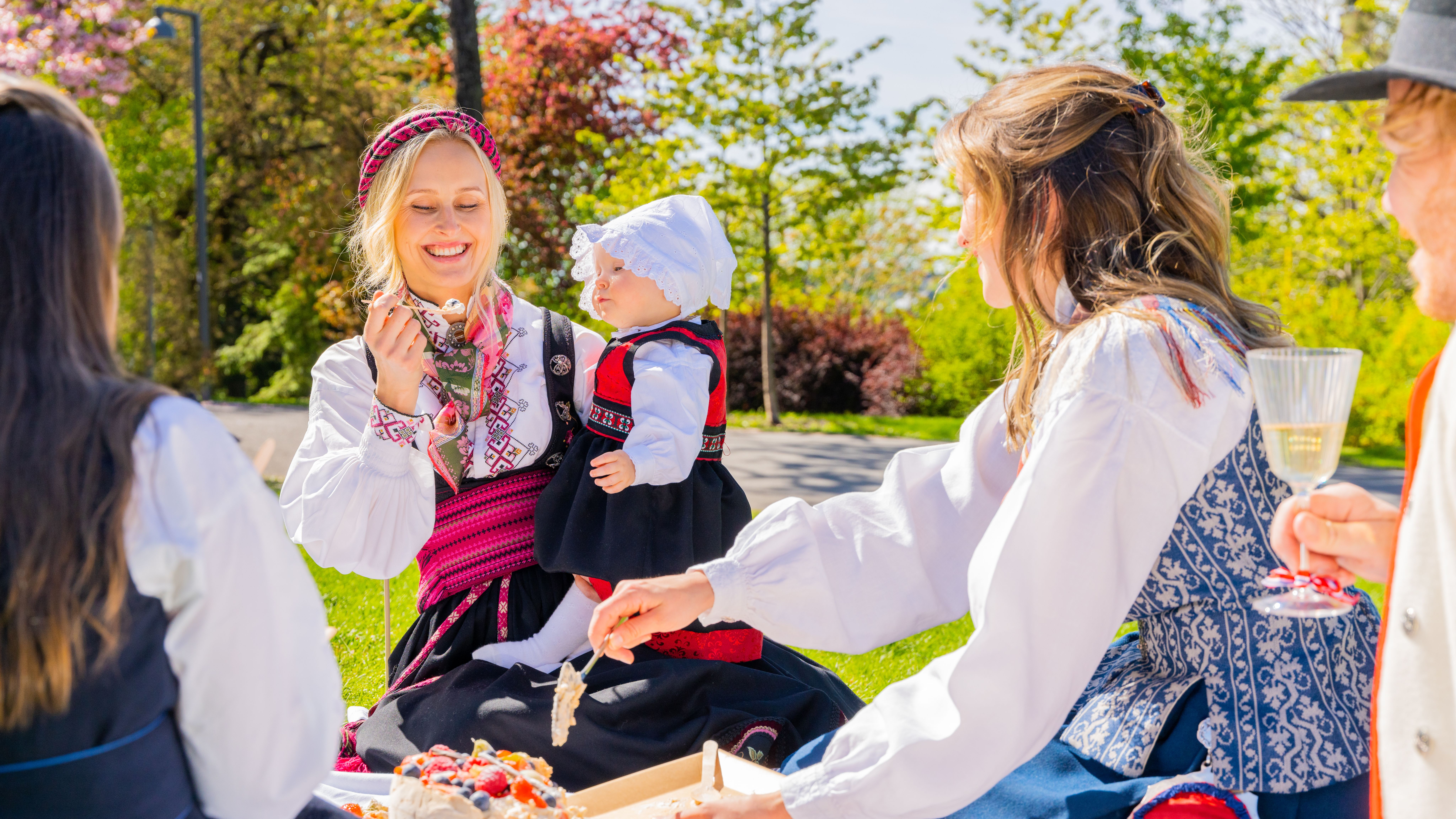 People in bunads having picnic in the park on May 17th, Norway's national day