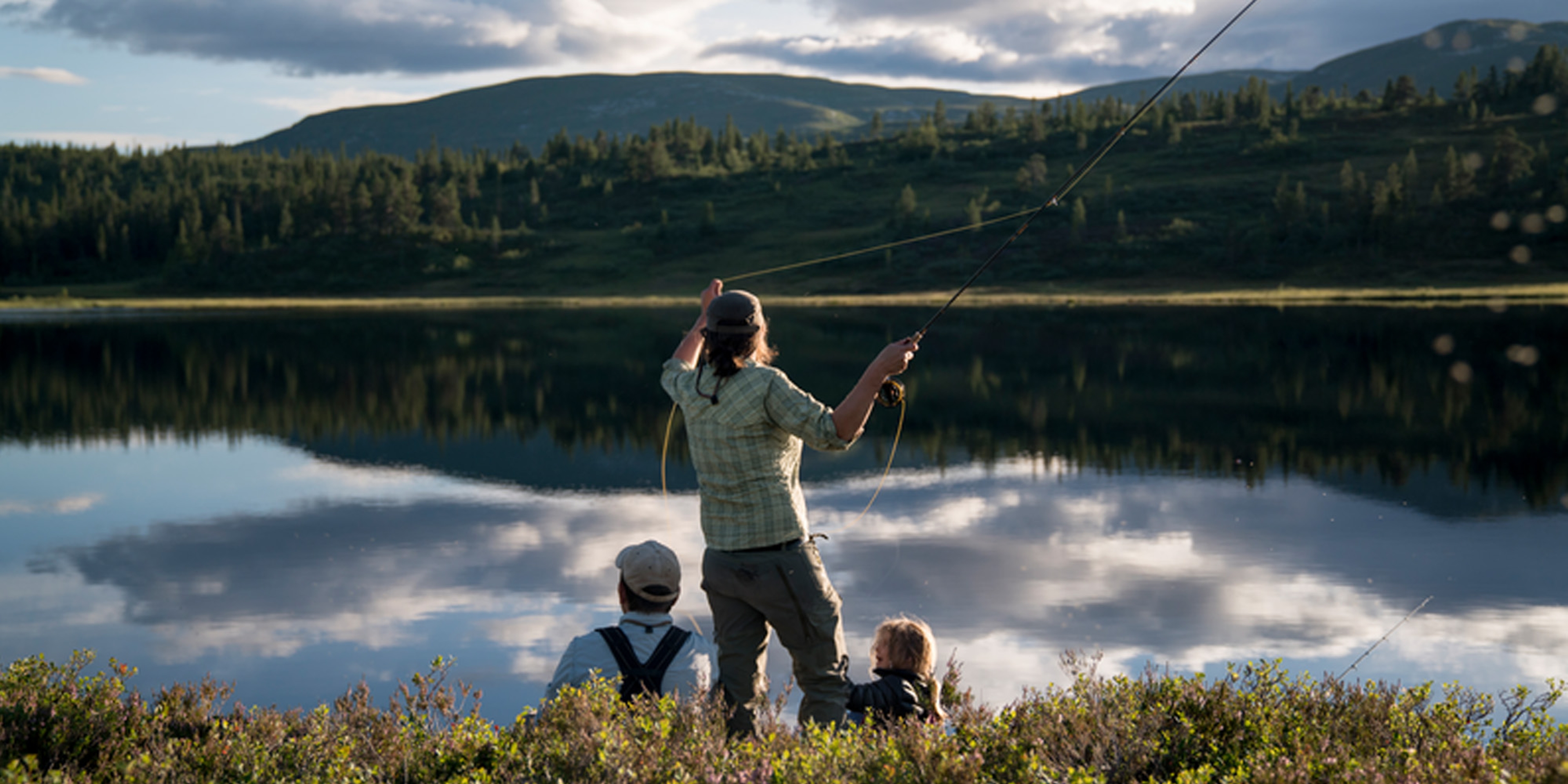 A woman and her family is fly-fishing in a lake in Blefjell, Eastern Norway