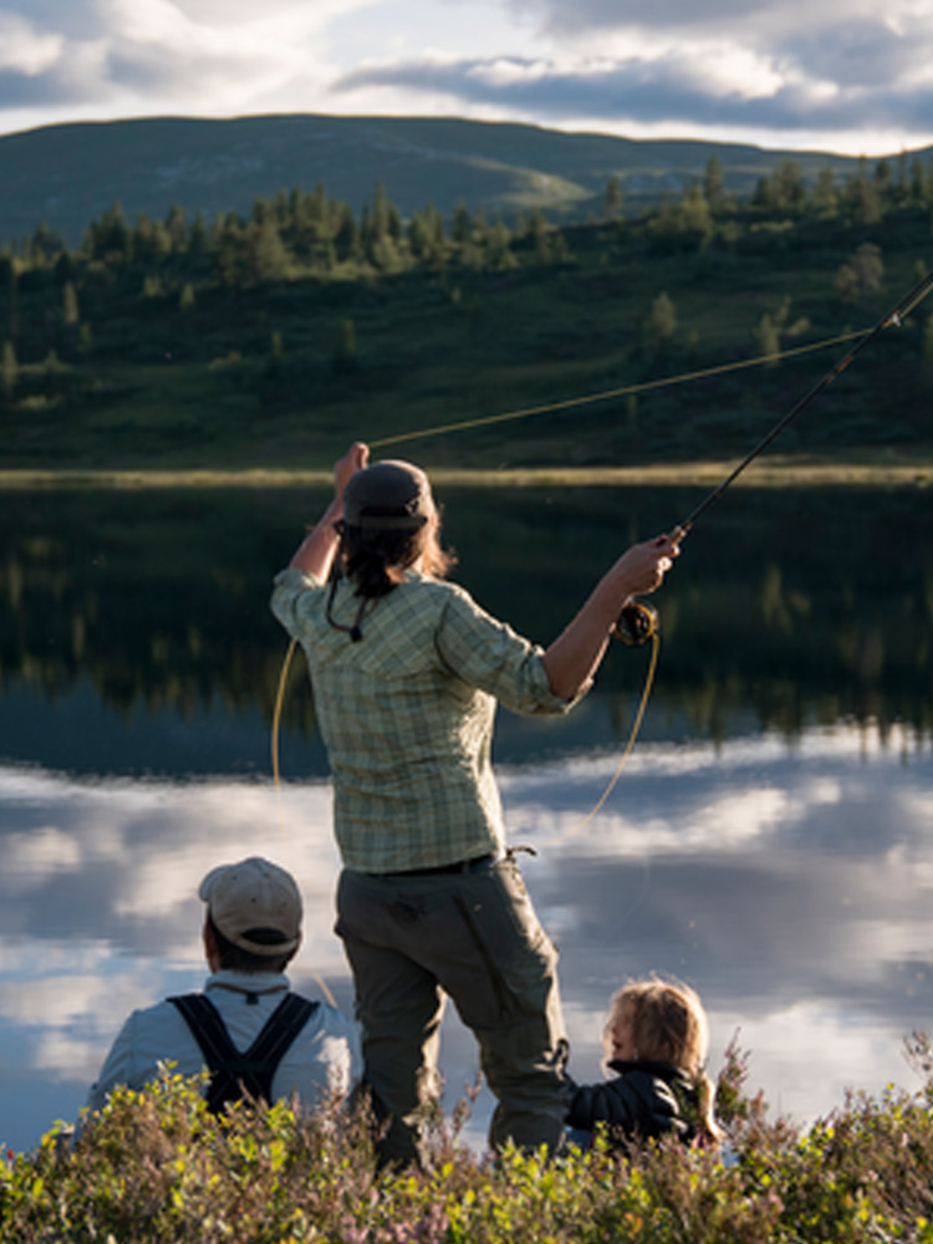 A woman and her family is fly-fishing in a lake in Blefjell, Eastern Norway