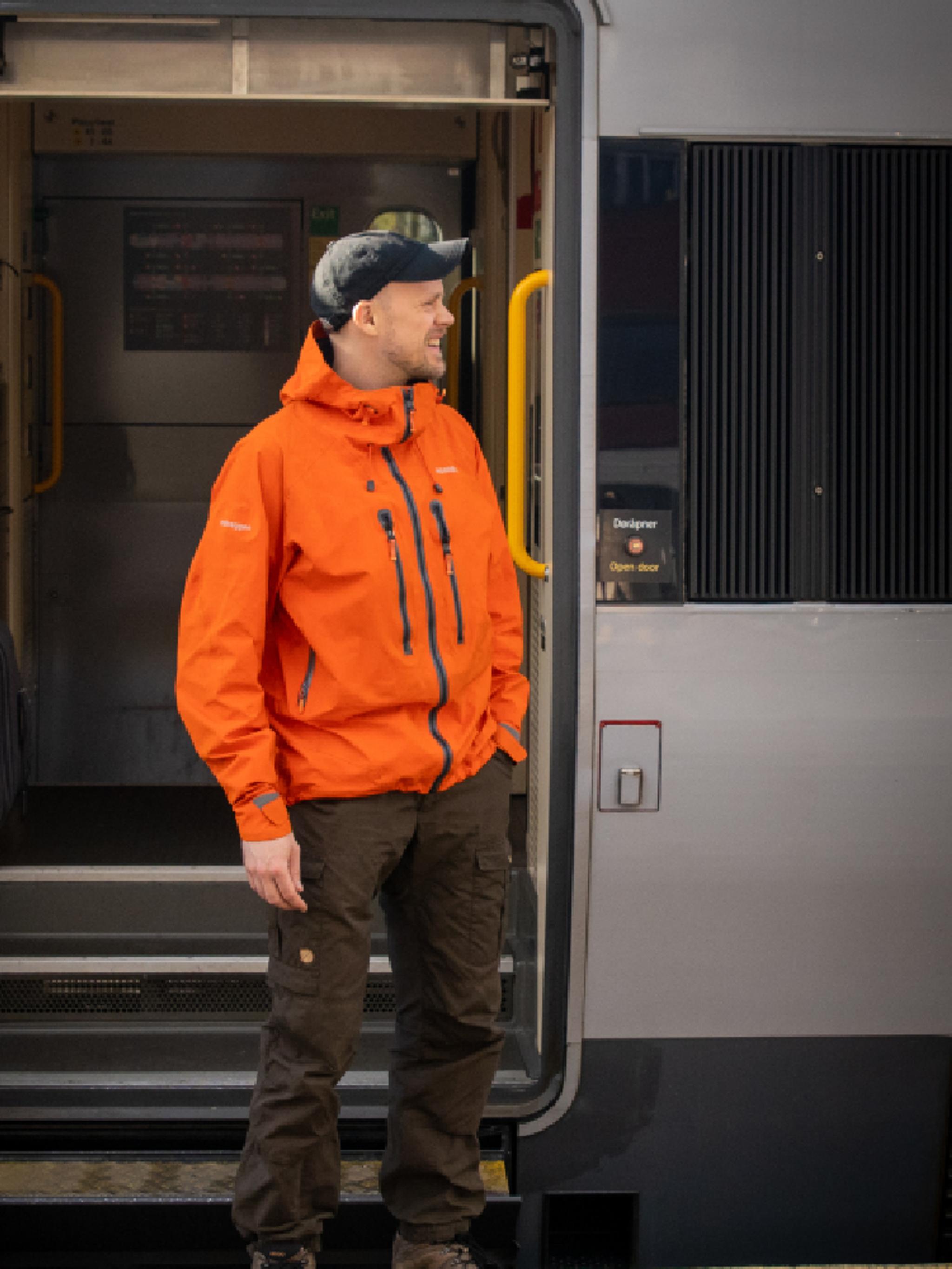 A man getting on board on the Dovre Railway train.