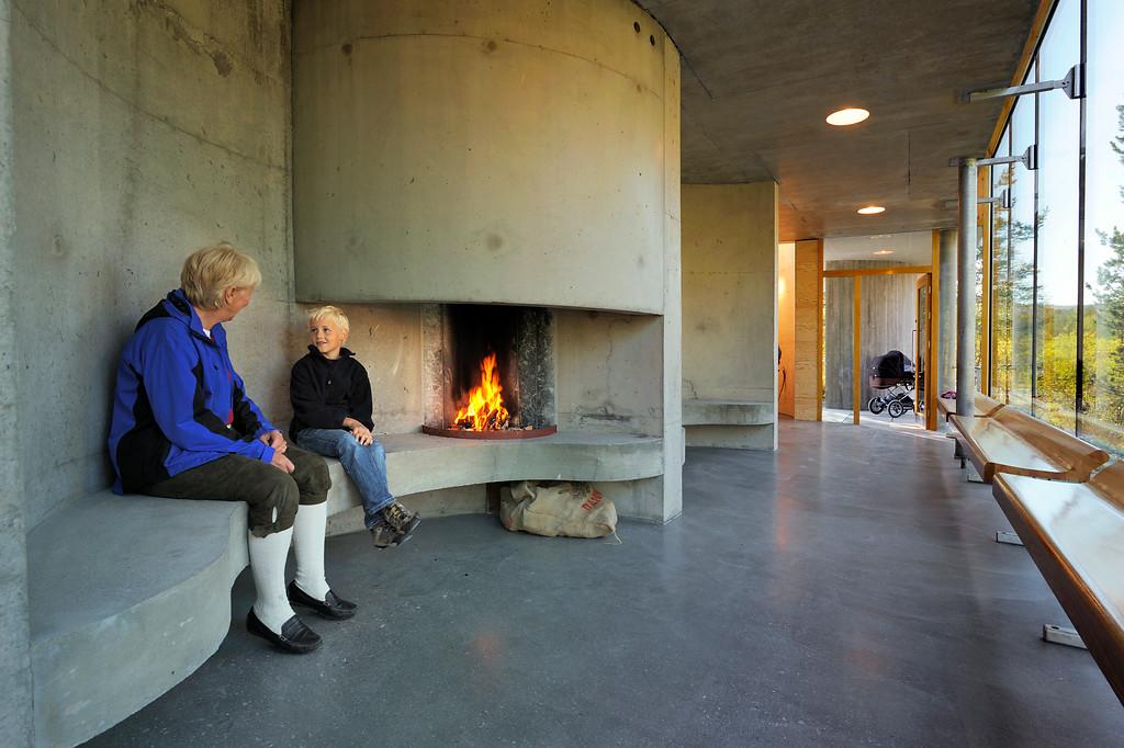 People enjoying a warm fire in a concrete building