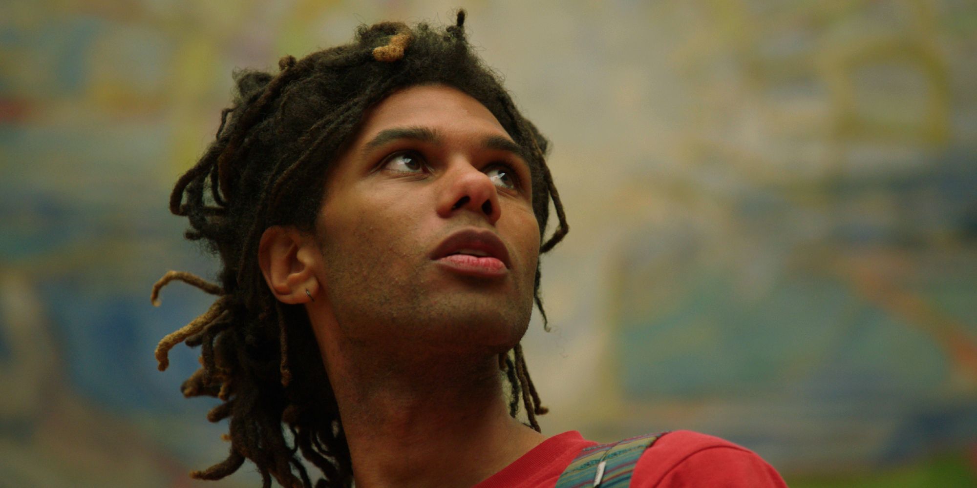 A mann is looking at art.