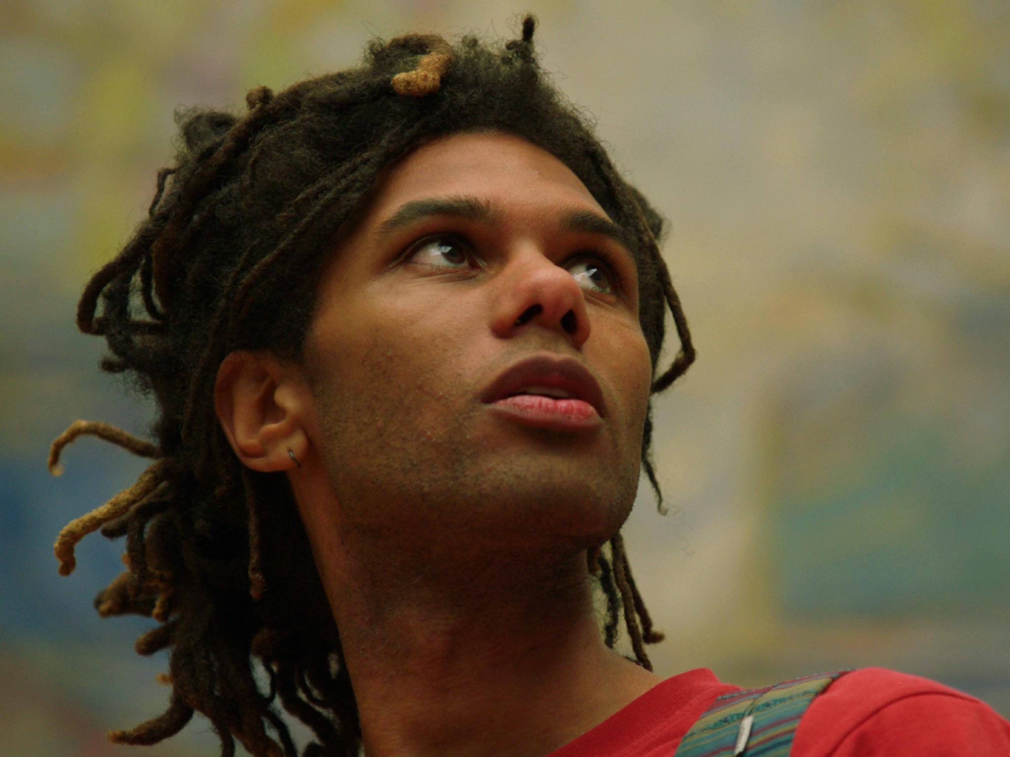 A mann is looking at art.