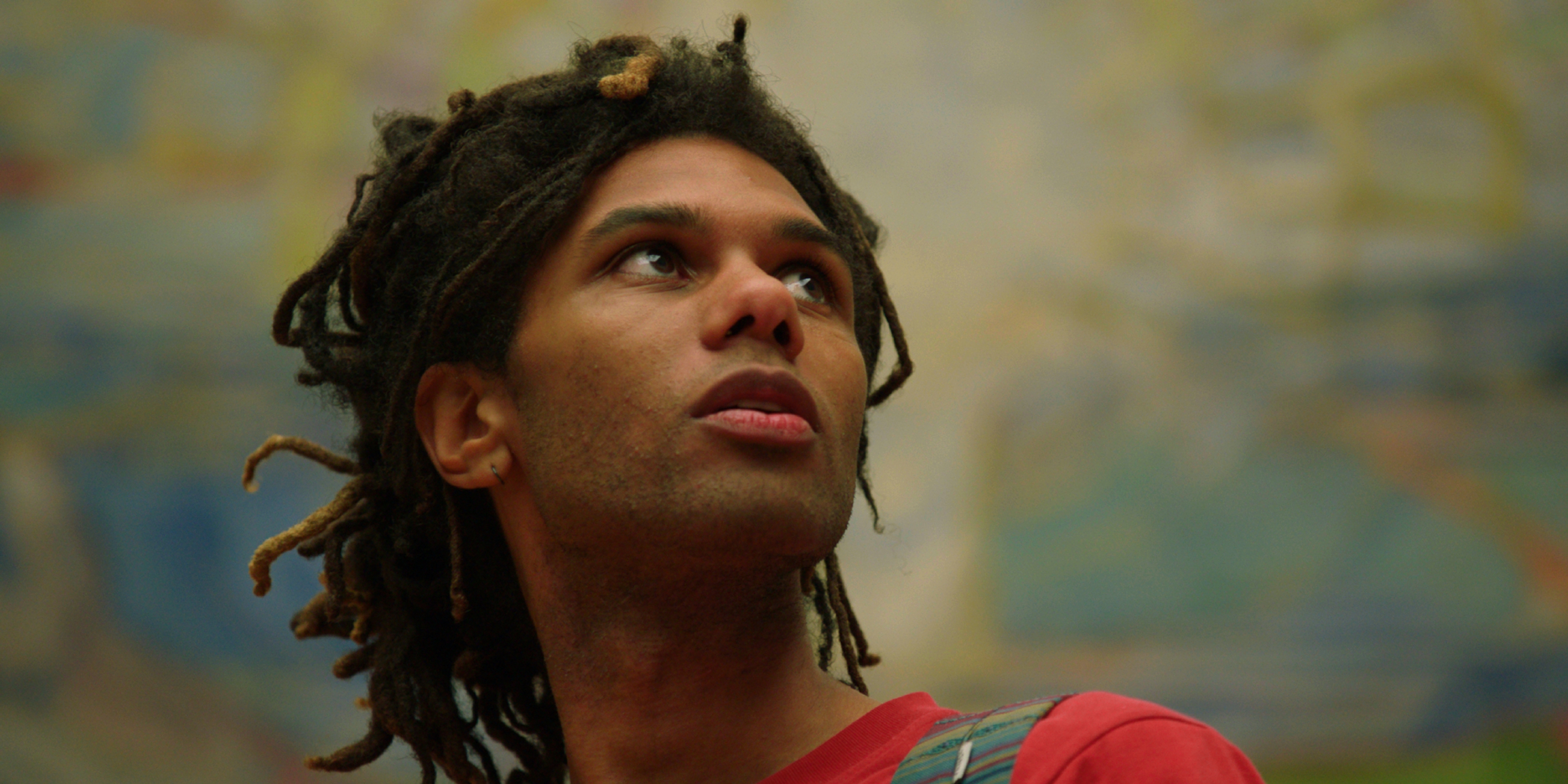 A mann is looking at art.