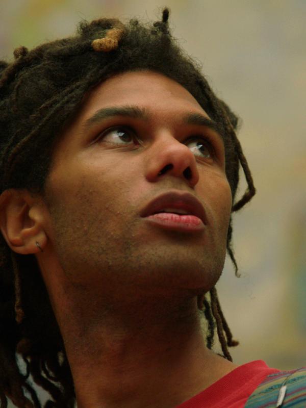 A mann is looking at art.