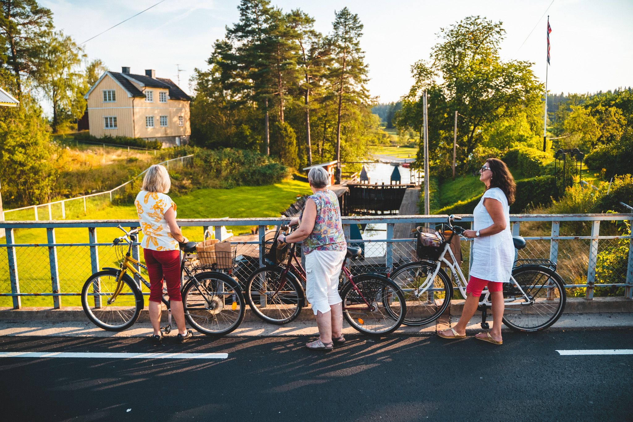 Three women with bikes by the Halden Canal in Eastern Norway.