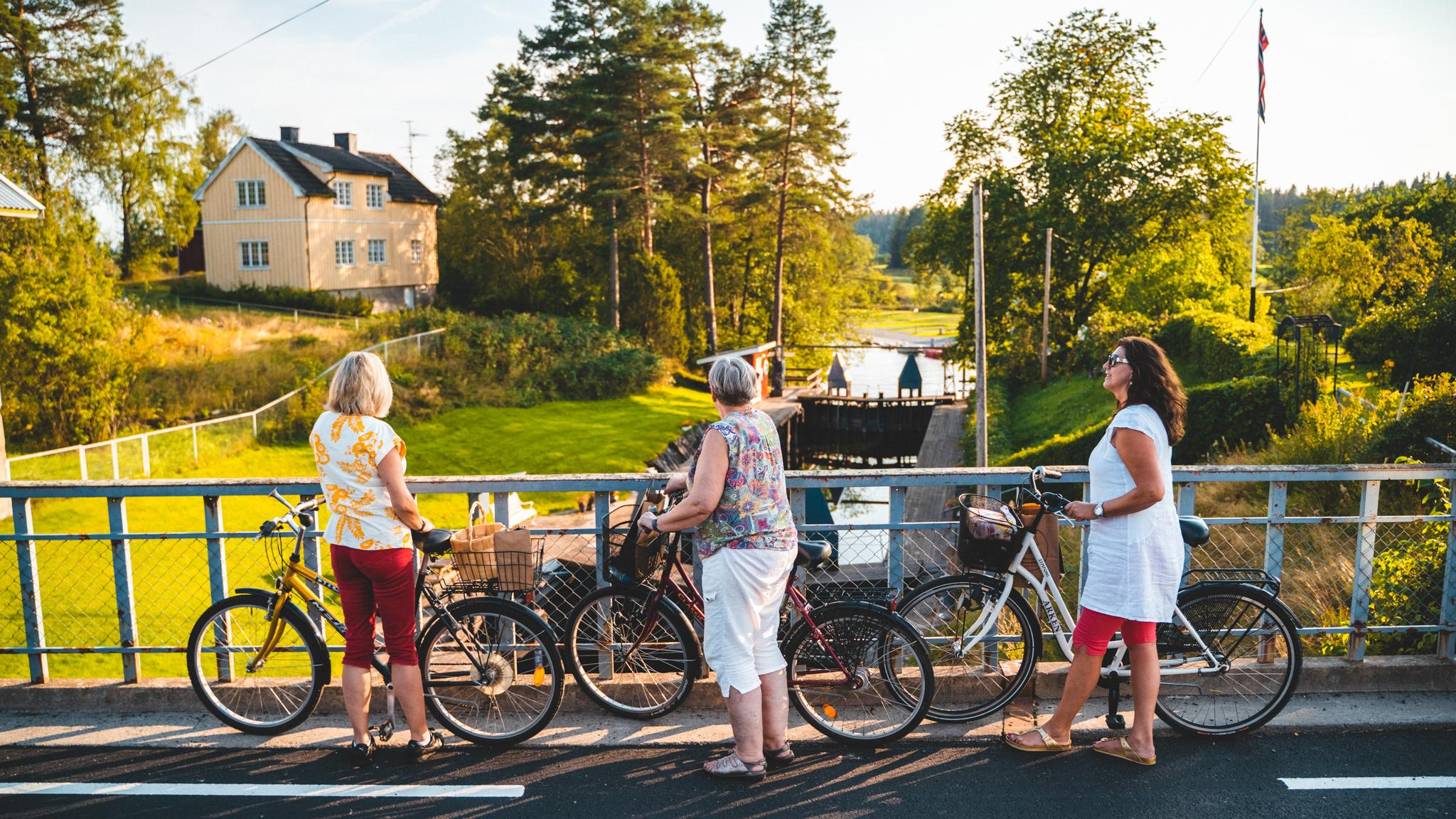 Three women with bikes by the Halden Canal in Eastern Norway.