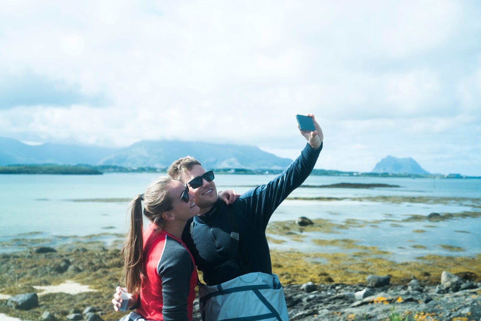 Couple taking a selfie at Vega in Northern Norway