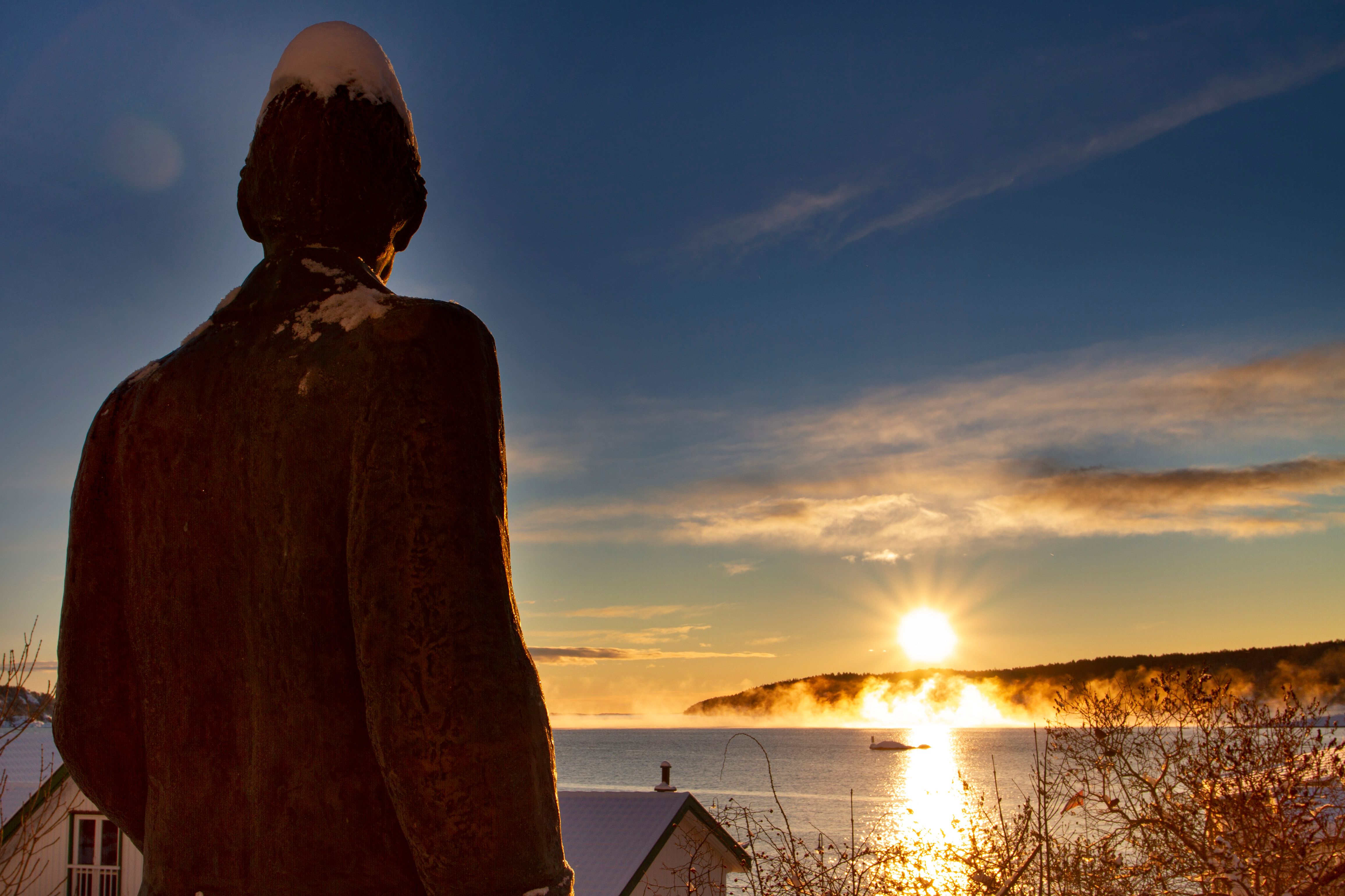 The sun rises over the Munch statue in Kragerø - Eastern Norway