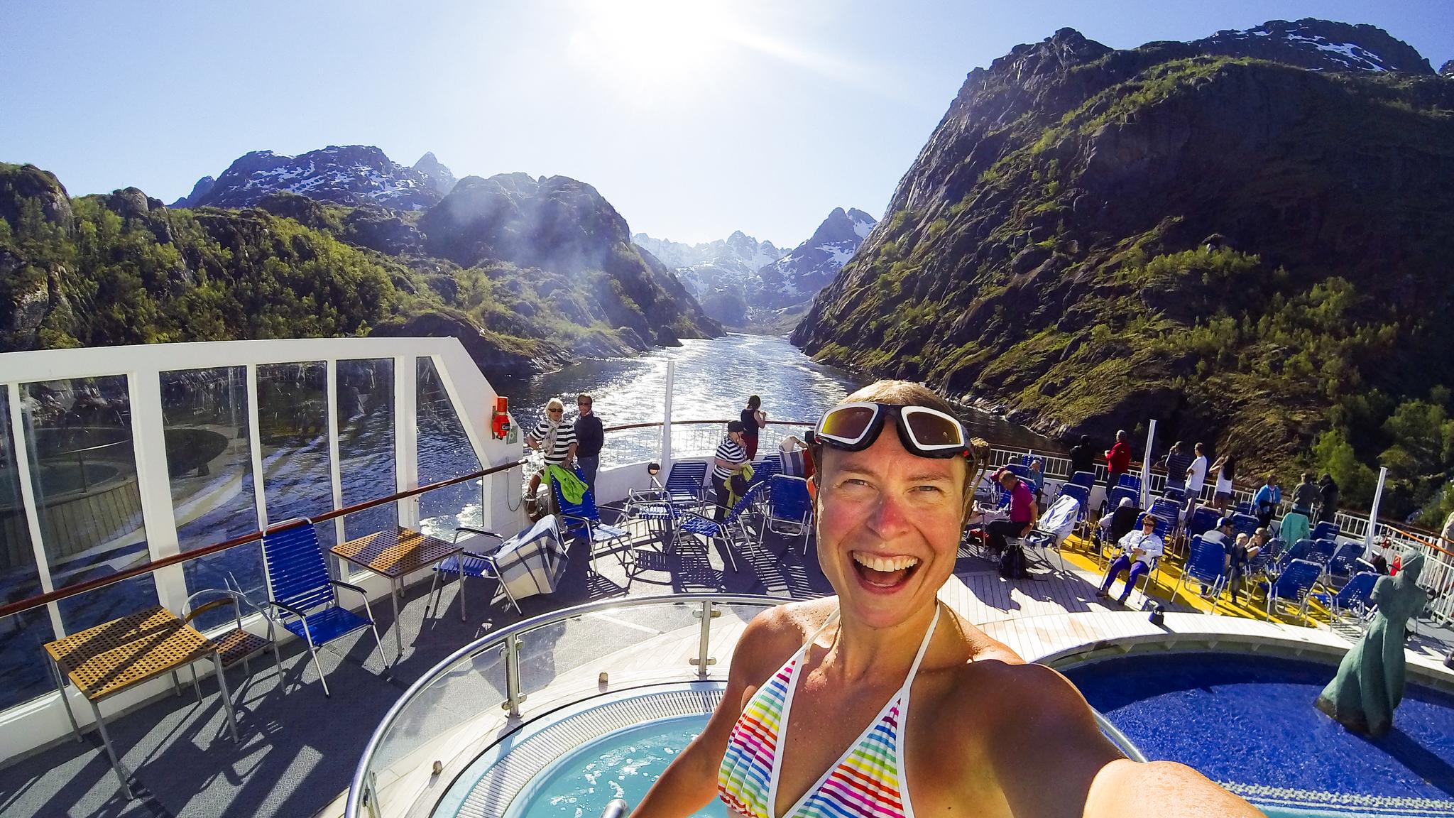 Woman taking selfie on a cruise on the Trollfjord in Vesterålen, Northern Norway